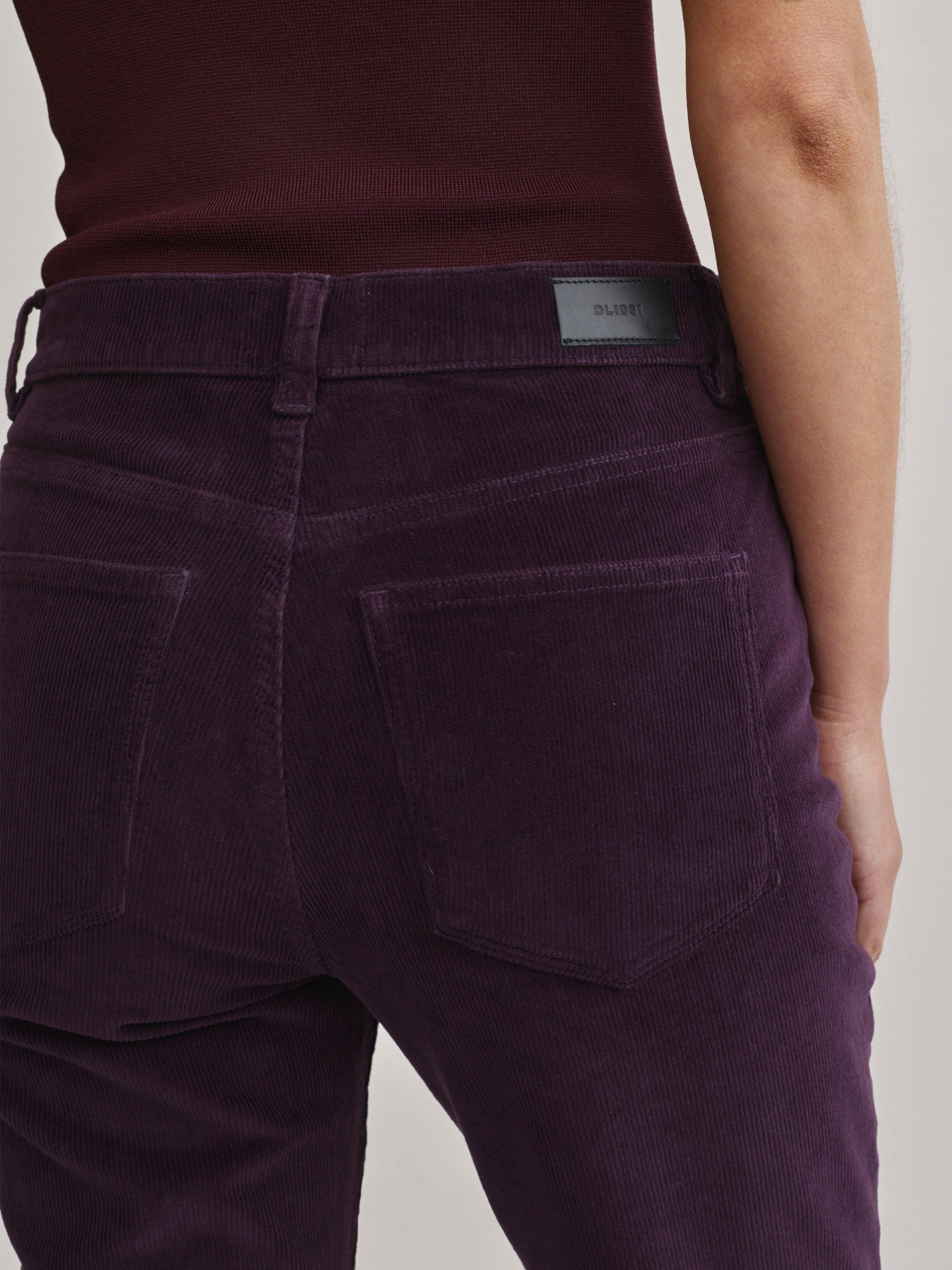DL1961 Bridget Bootcut Instasculpt jeans in aubergine corduroy 'Blackberry Cord', back pocket and DL1961 patch detail.