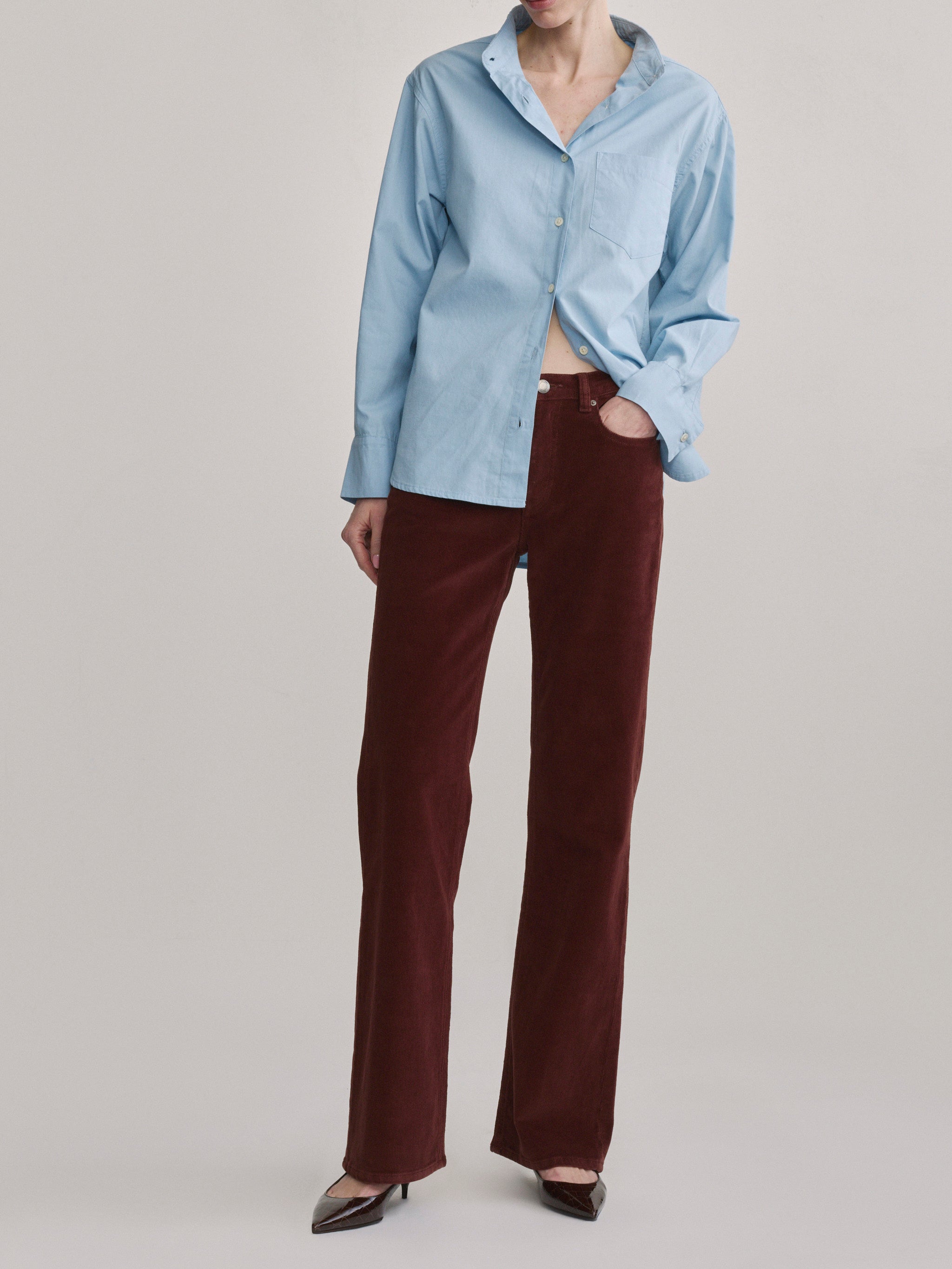 DL1961 Bella slim bootcut mid-rise corduroy jeans in wine 'Syrah Cord', front view with light blue shirt.