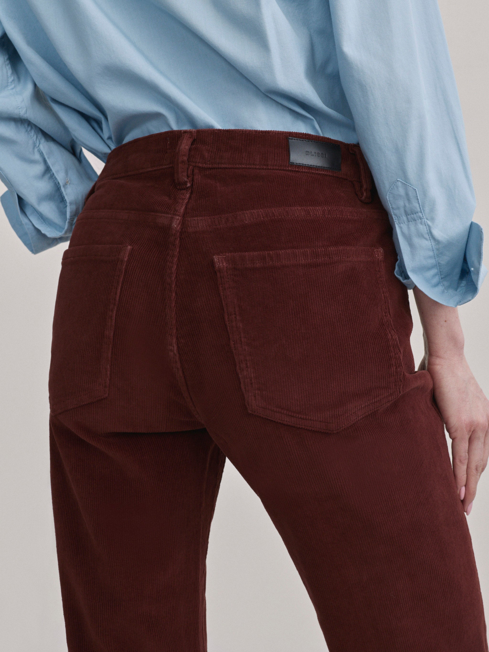 DL1961 Bella slim bootcut mid-rise corduroy jeans in wine 'Syrah Cord', close-up of back pocket and corduroy wale.