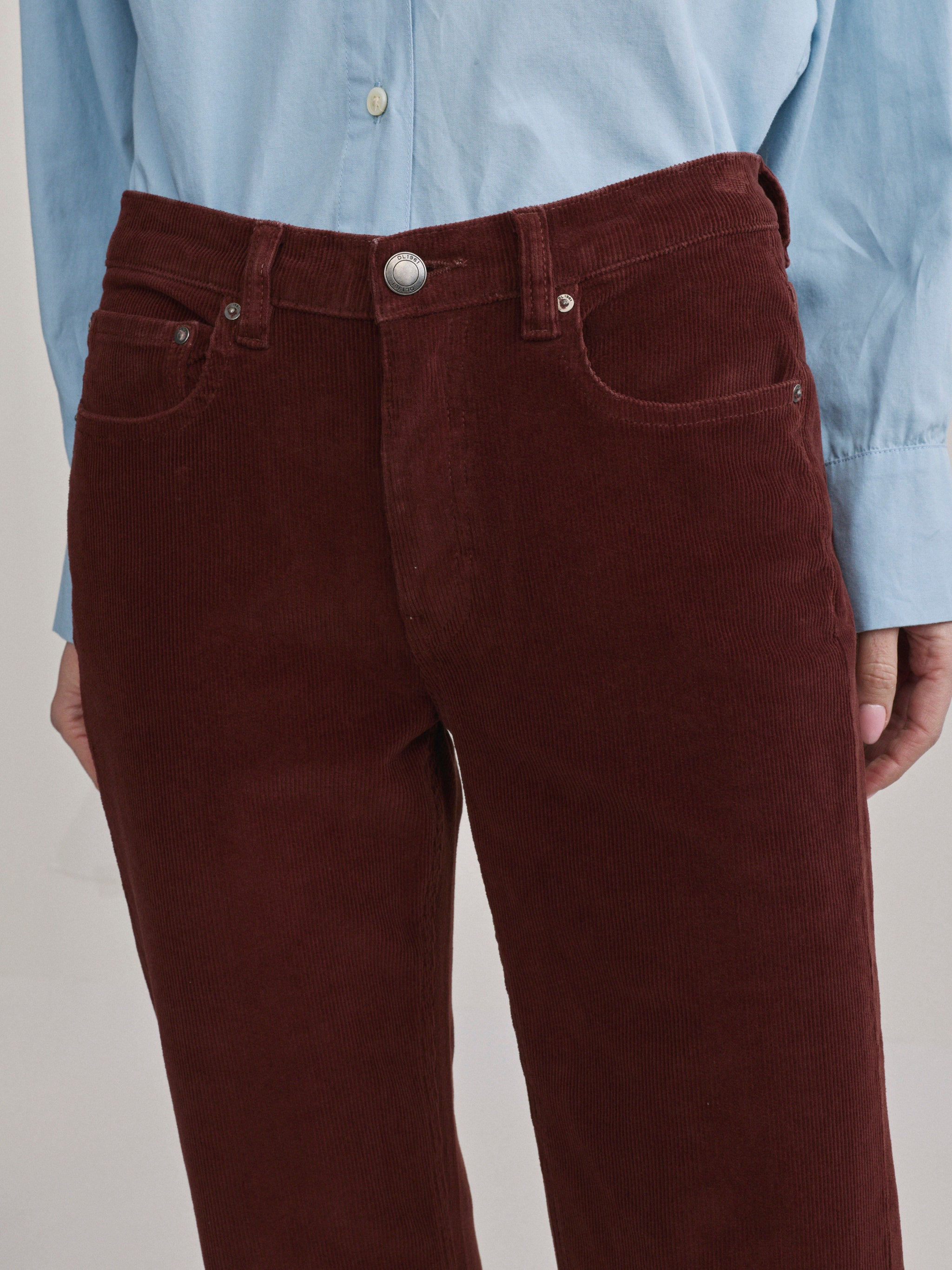 DL1961 Bella slim bootcut mid-rise corduroy jeans in wine 'Syrah Cord', close-up of wale texture and front pocket.
