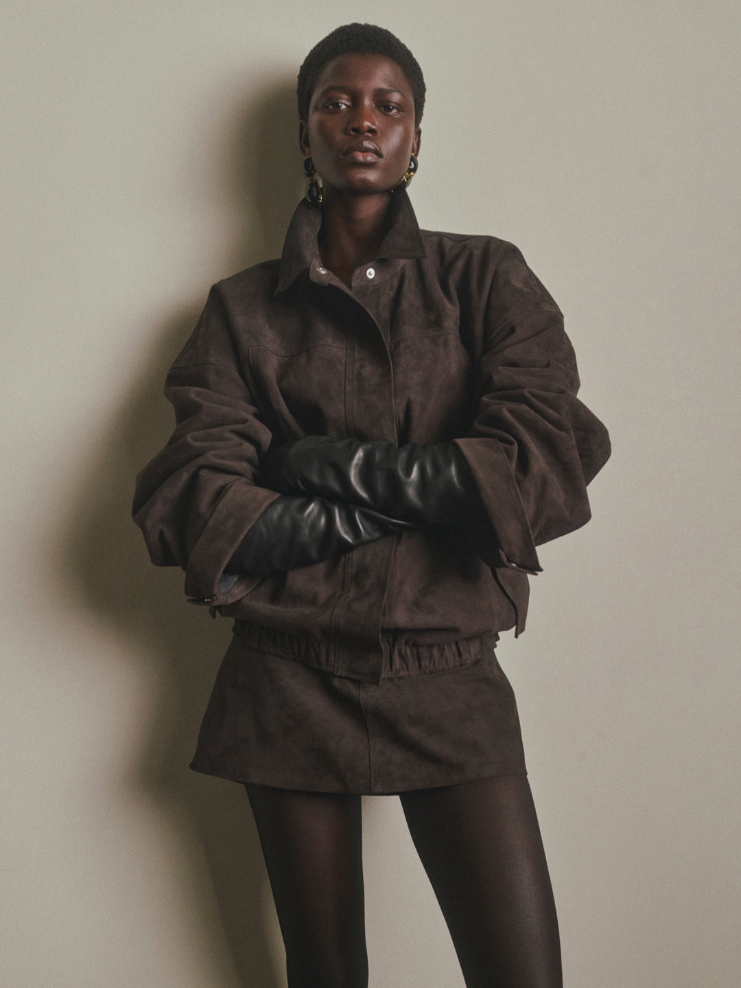 DL1961 Avalon Mini Low-Rise Suede Skirt in brown Tobacco Suede, styled with matching suede jacket, front view.
