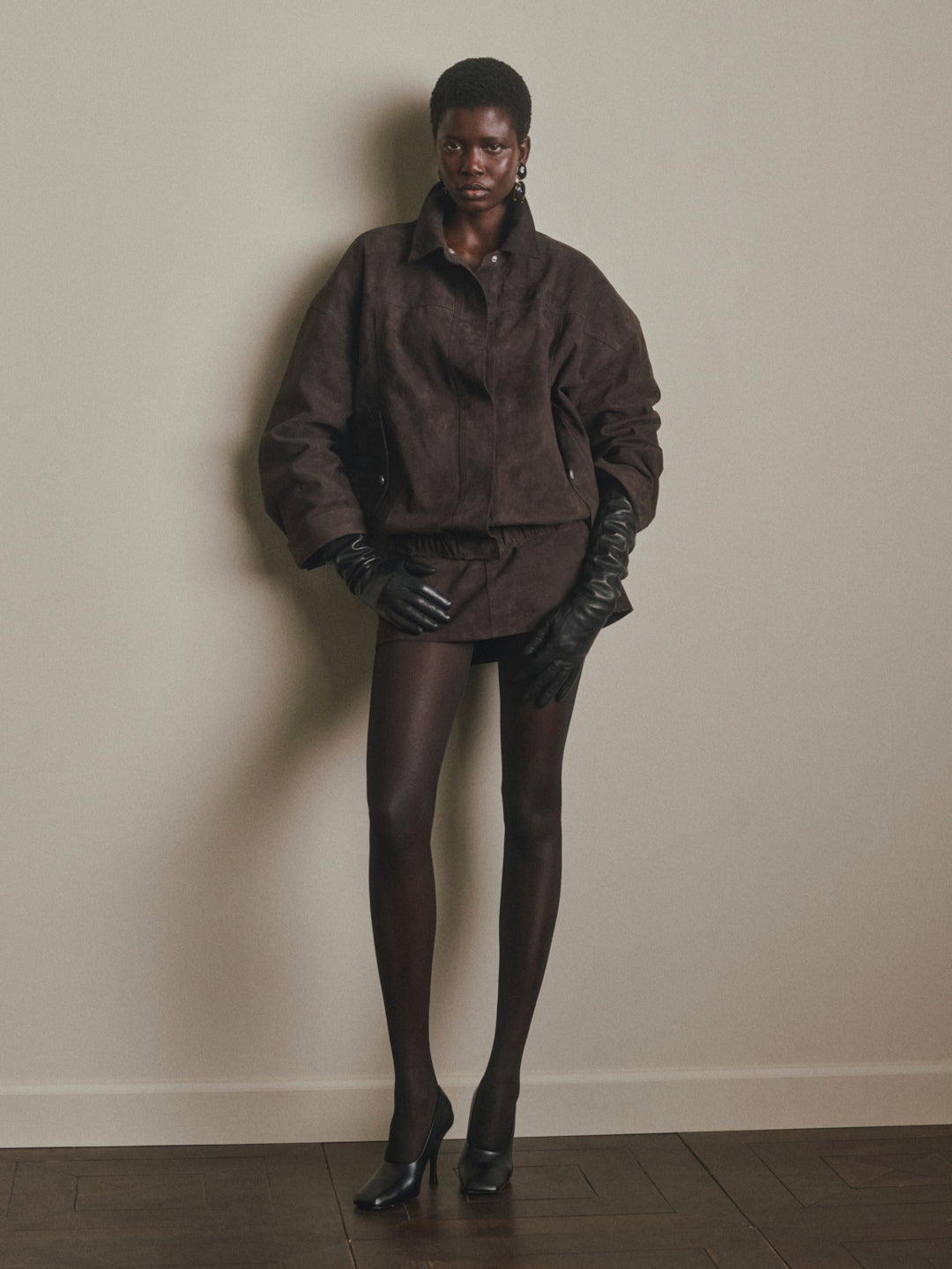 DL1961 Avalon Mini Low-Rise Suede Skirt in brown Tobacco Suede, three-quarter view with suede jacket.