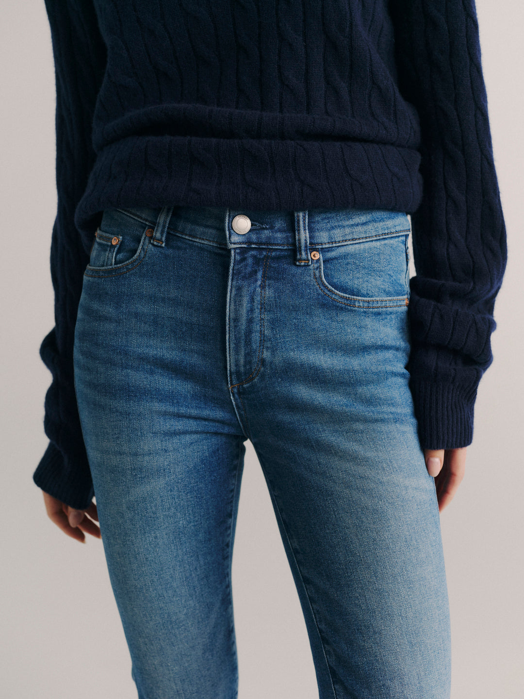Mara jeans in Crisp Air, close-up of the high-rise waist and front pockets on a model.