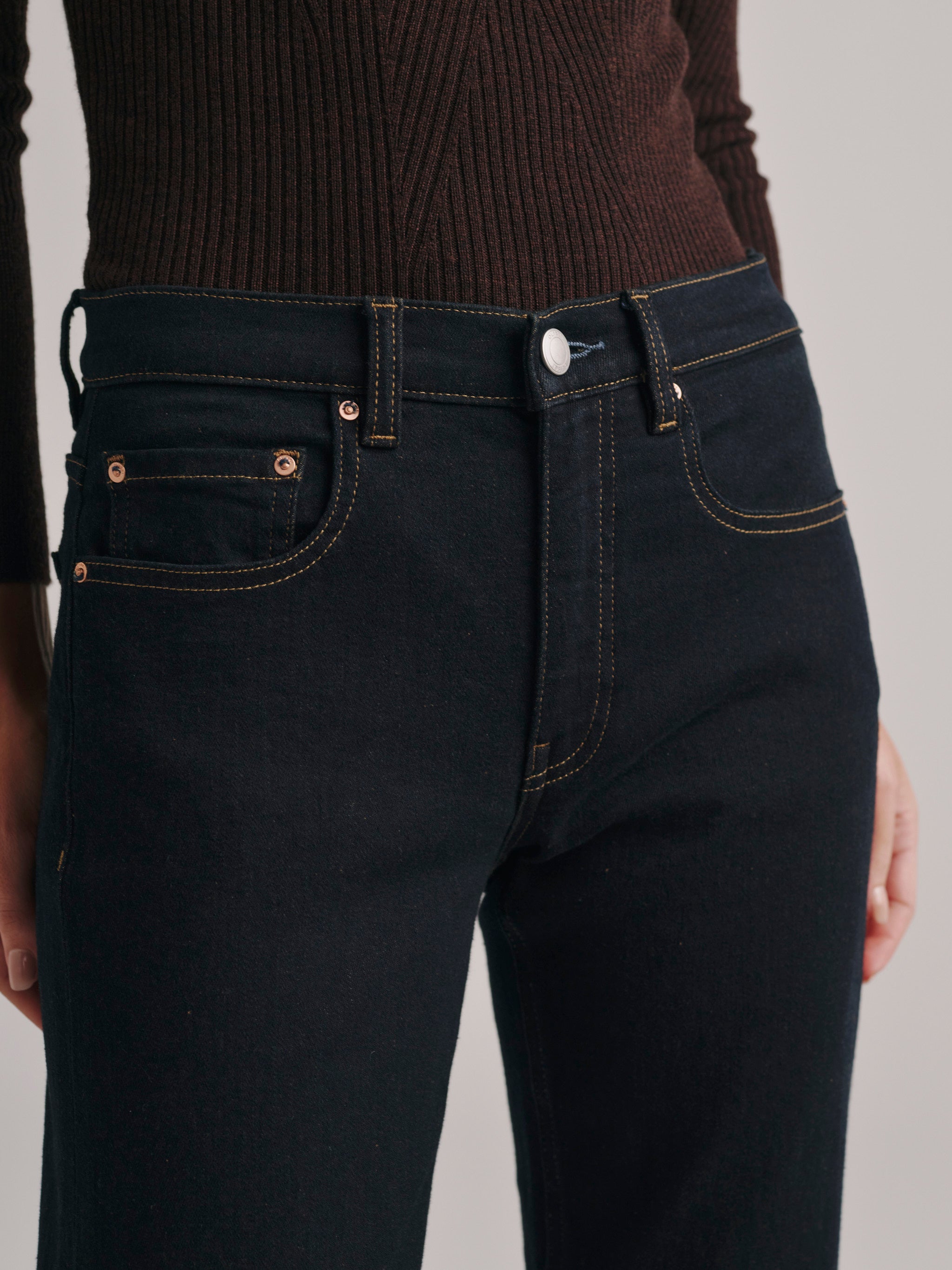 DL1961 Bella Slim Bootcut mid-rise jeans in dark indigo rinse 'Harvest Moon', close-up of front waist.