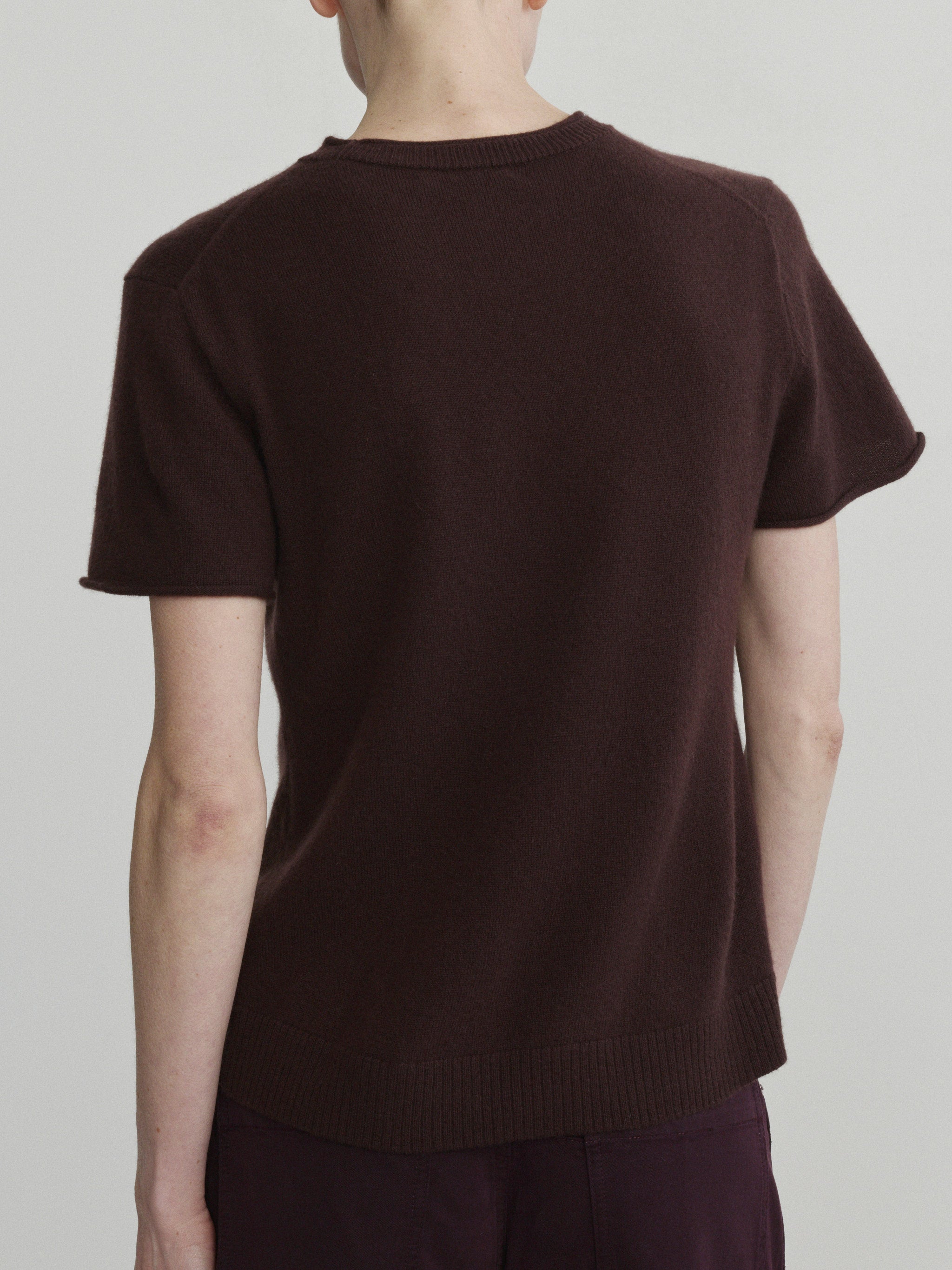Bilie Easy Barrel jeans in Viola with Brown Knit Tee, model back view, upper-body crop.