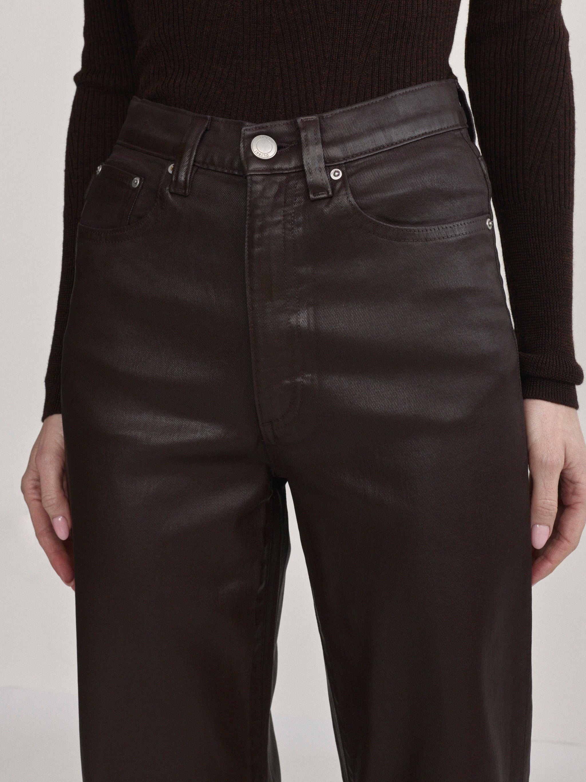 DL1961 Karmine wide-leg high-rise jeans in coated dark berry-brown 'Bramble Coated', front waistband detail.