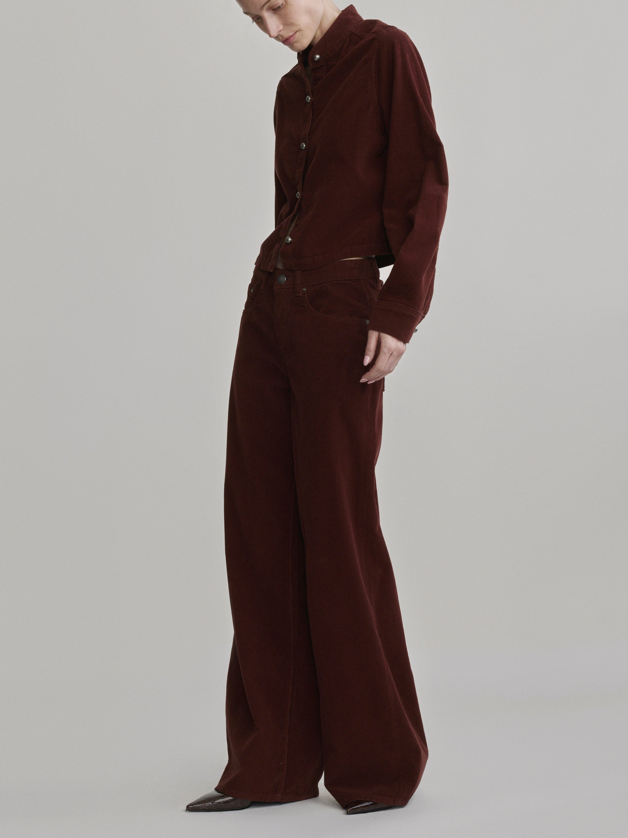 DL1961 Charlotte Shirt in wine corduroy 'Syrah Cord', side view of the cropped shirt and wide pants.
