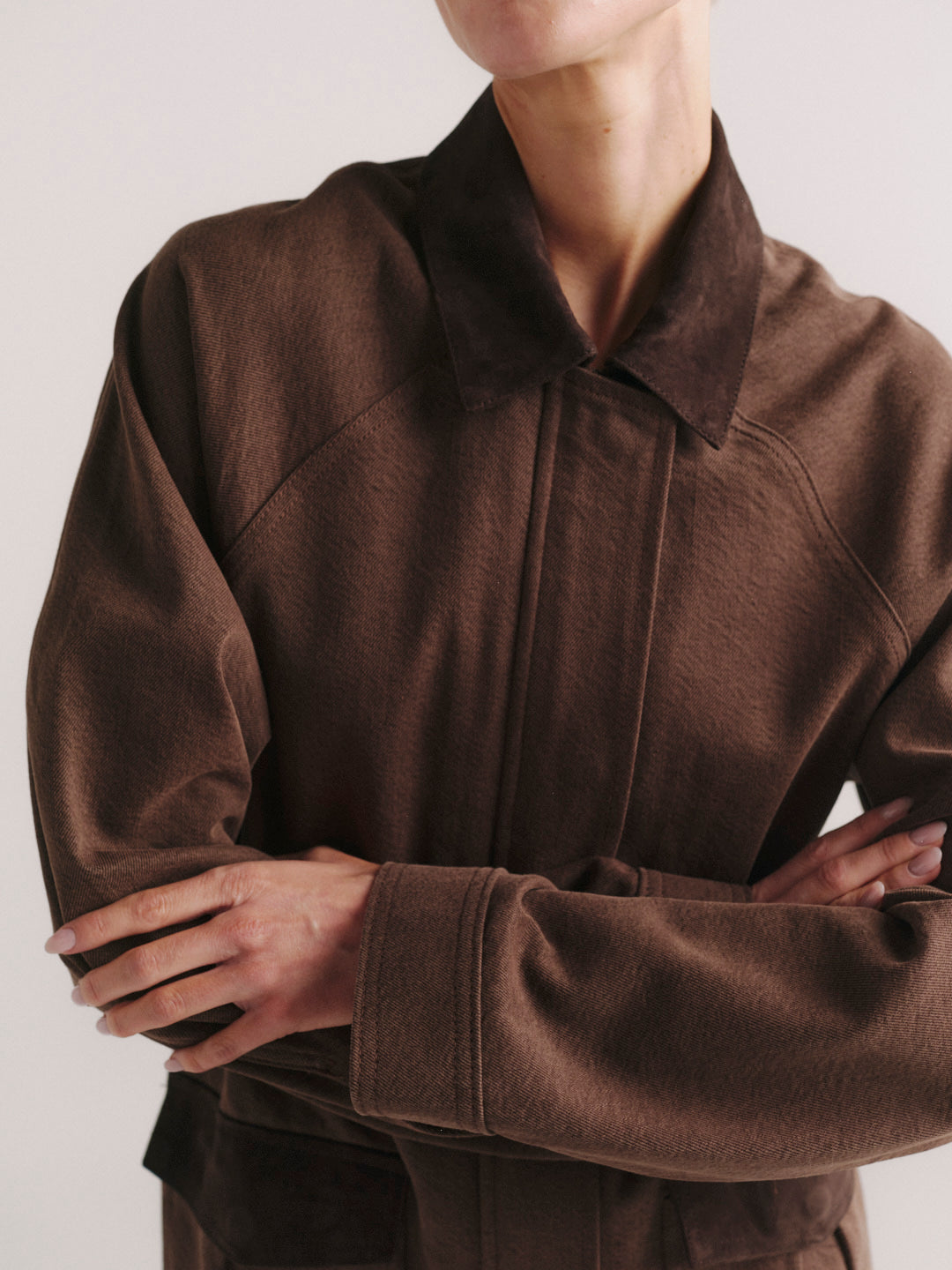 Cate Slim jeans in Mid Dark with Brownstone Field Jacket, close-up of collar and crossed arms.