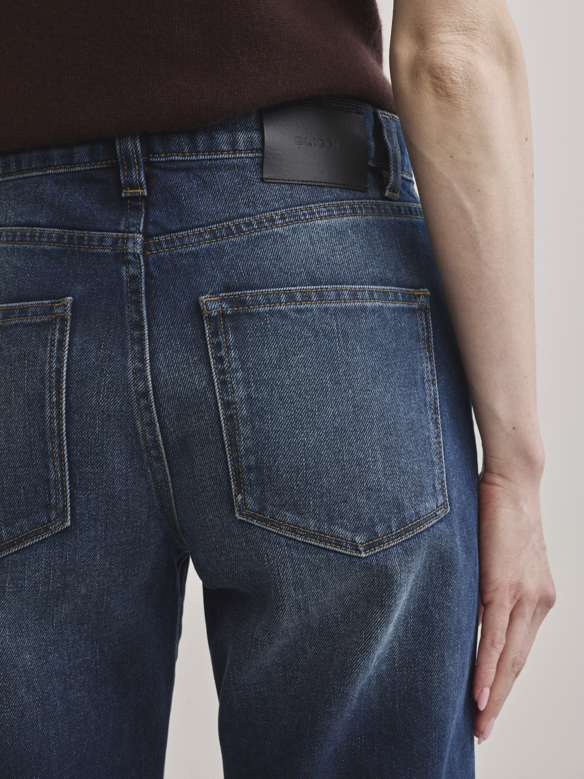 DL1961 Dakota slim straight low-rise jeans in medium blue 'Drama', back pocket detail with leather logo patch.