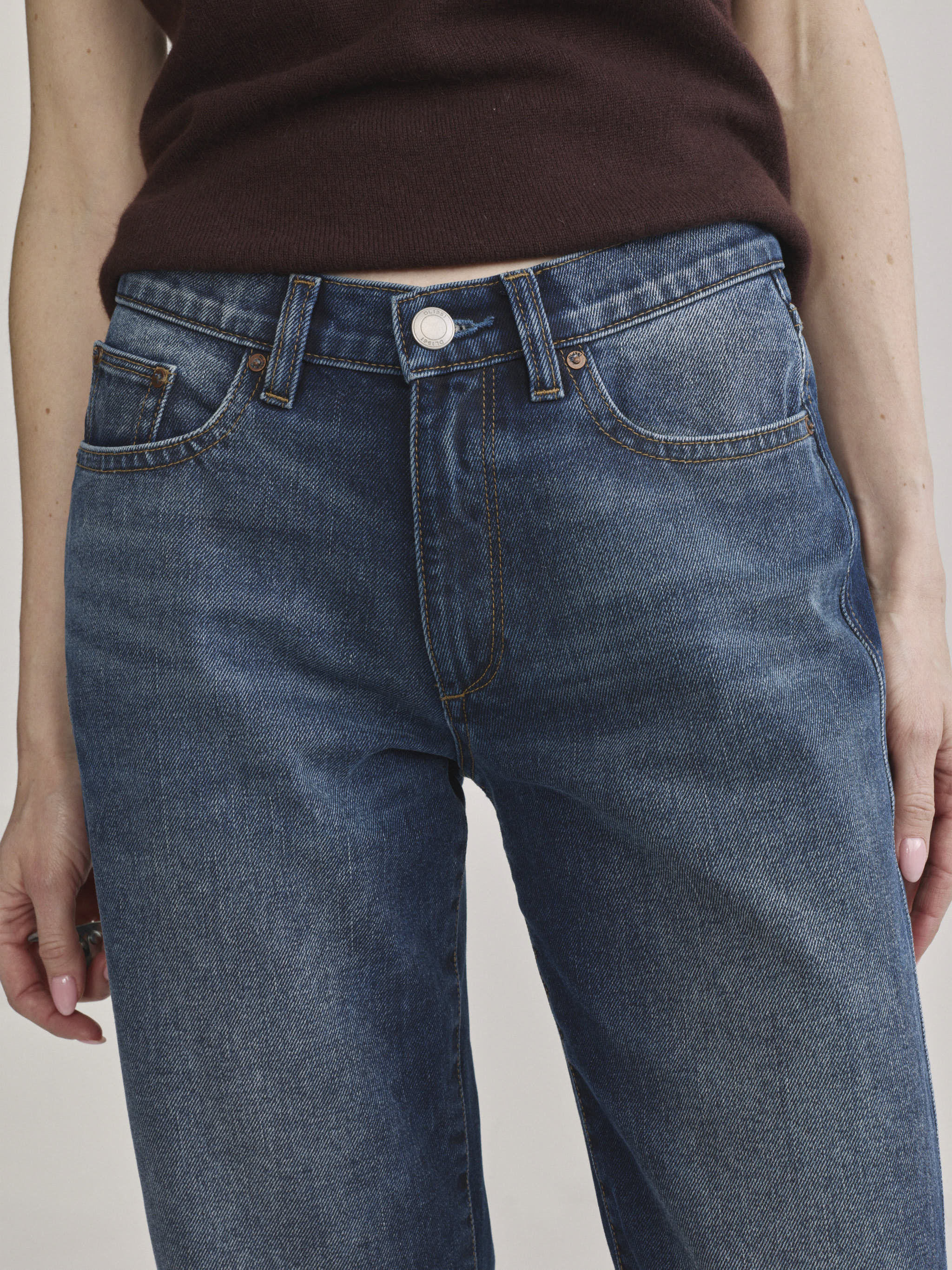 DL1961 Dakota slim straight low-rise jeans in medium blue 'Drama', close-up of low rise and faded whiskering.
