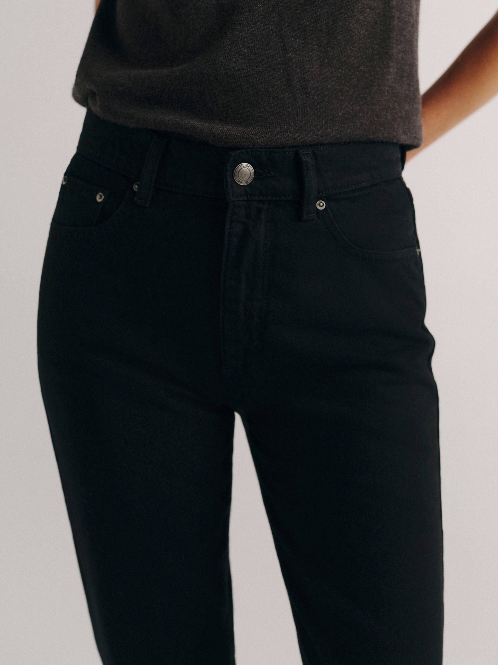 DL1961 women's Cate Classic Straight high rise jeans in black, close-up of the high rise waist, button and front pocket.