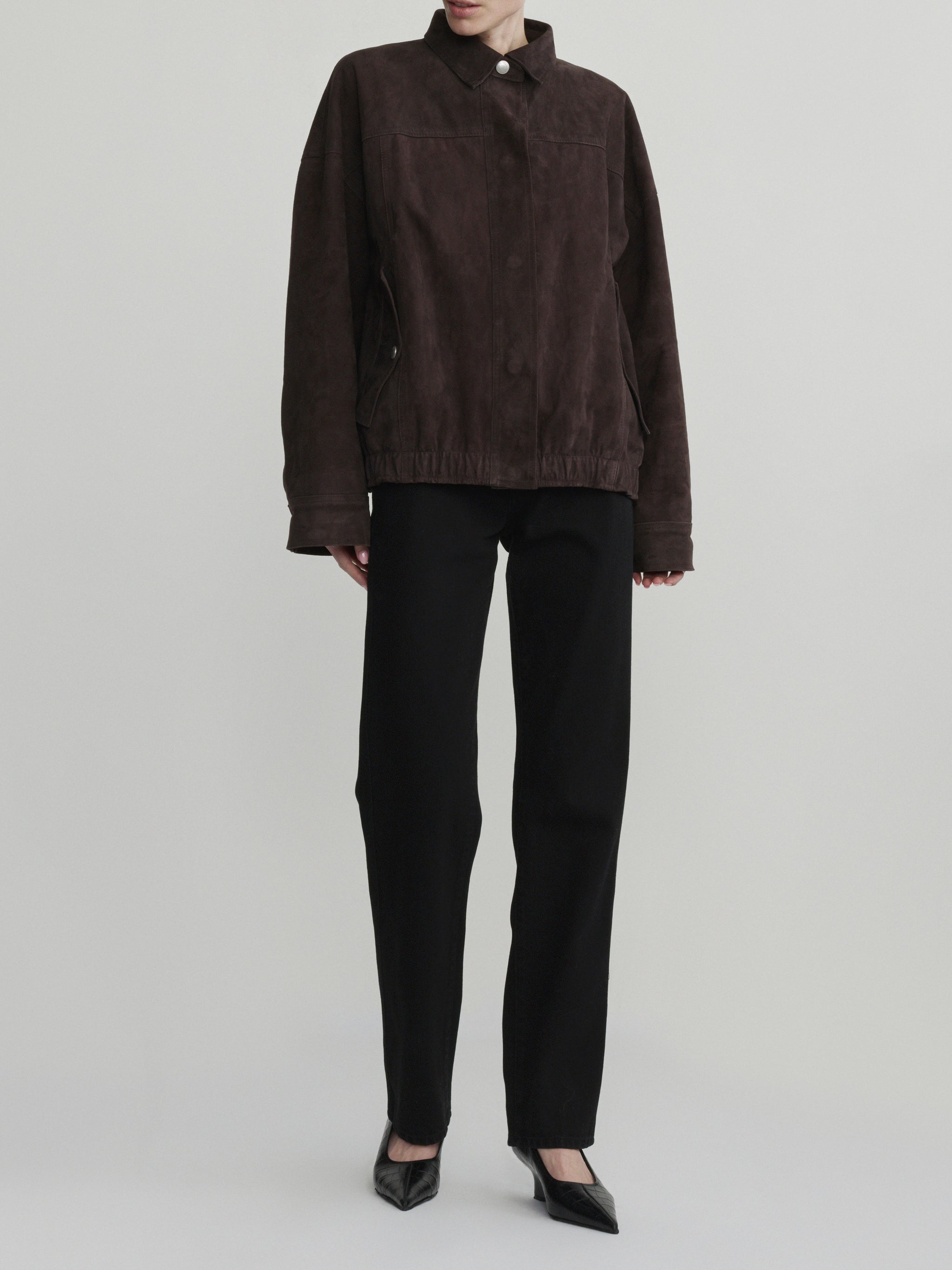 DL1961 Nara Oversized Suede Jacket in tobacco brown suede, oversized snap-front, styled with black jeans, full front.