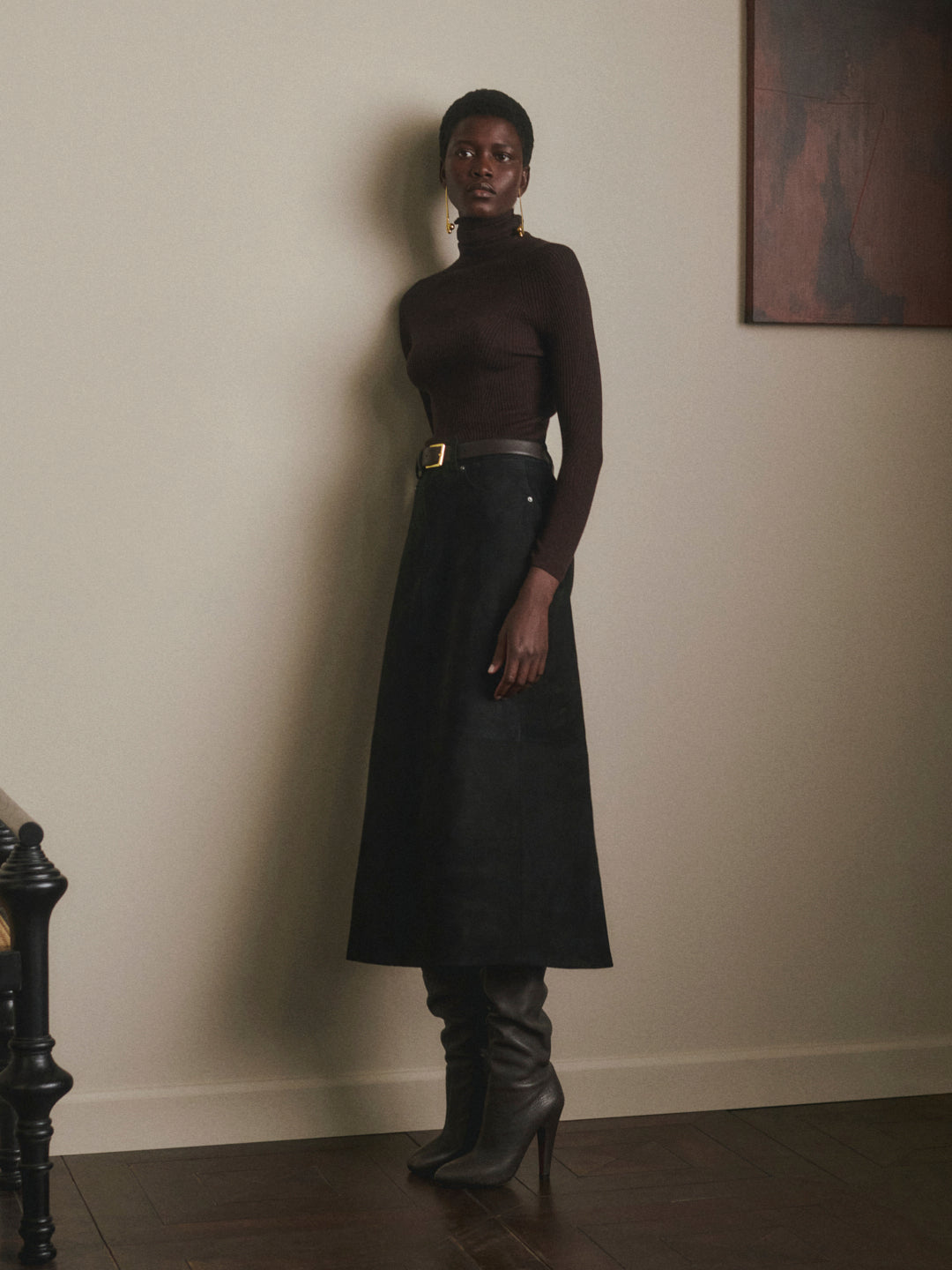 DL1961 Alma Suede Midi Skirt in Black Suede, A-line silhouette styled with brown turtleneck, front view.
