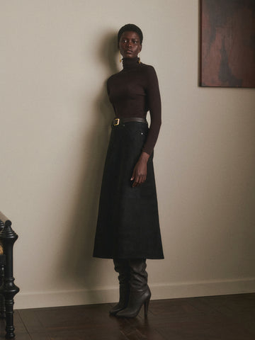 DL1961 Alma Suede Midi Skirt in Black Suede, A-line silhouette styled with brown turtleneck, front view.