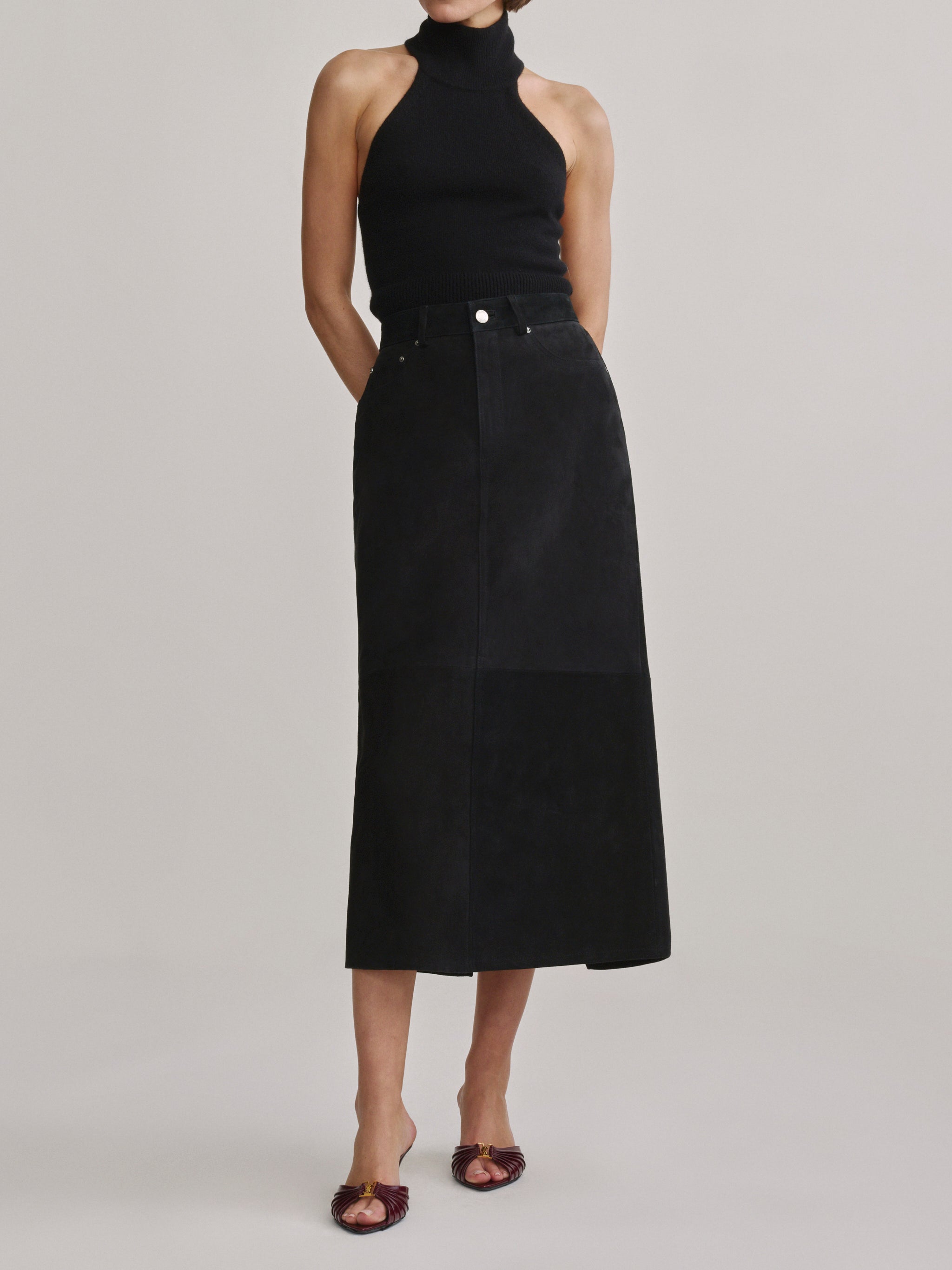 DL1961 Alma Suede Midi Skirt in Black Suede, A-line silhouette with black halter top, full front view.