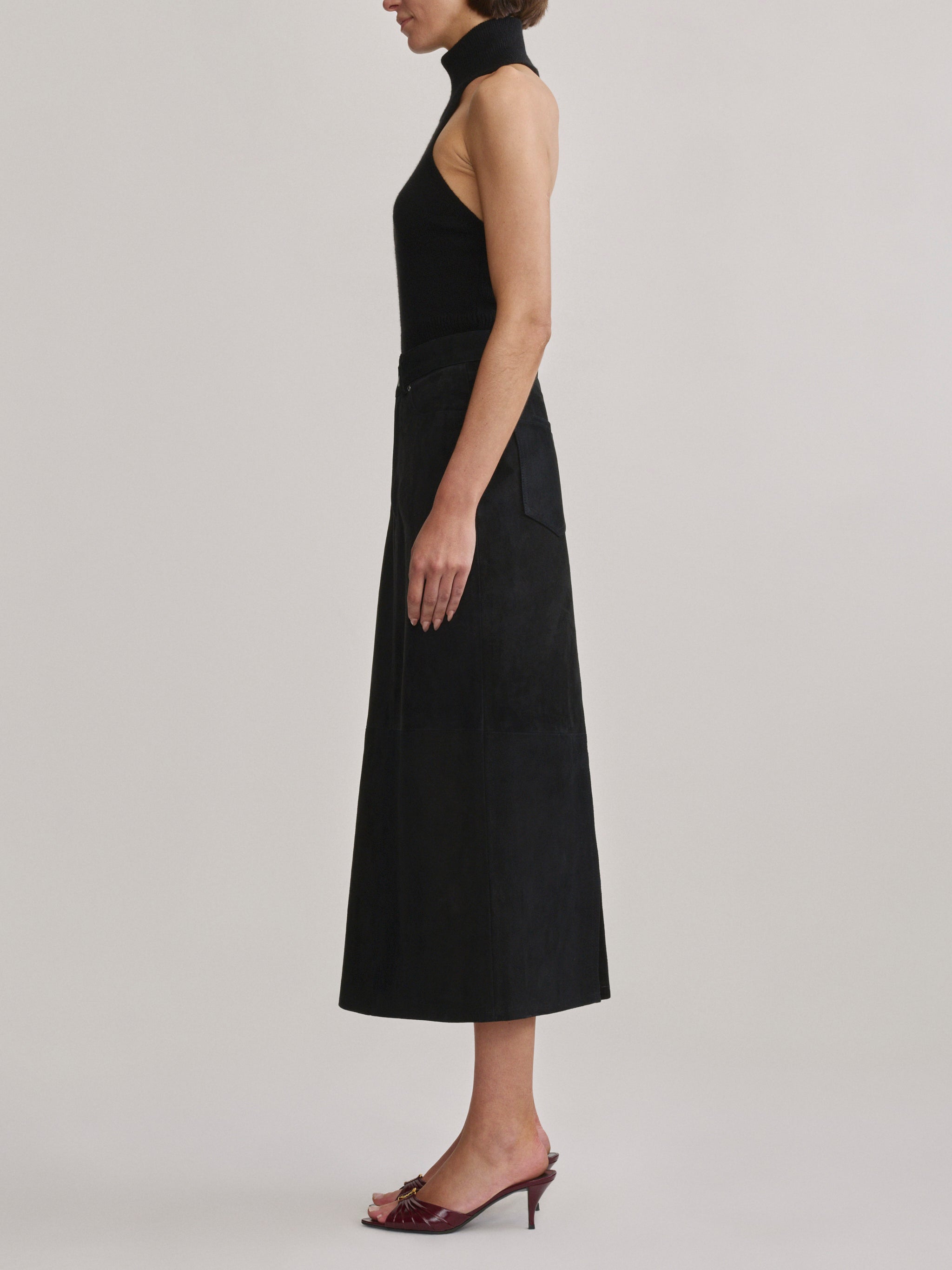 DL1961 Alma Suede Midi Skirt in Black Suede, A-line silhouette, side profile.