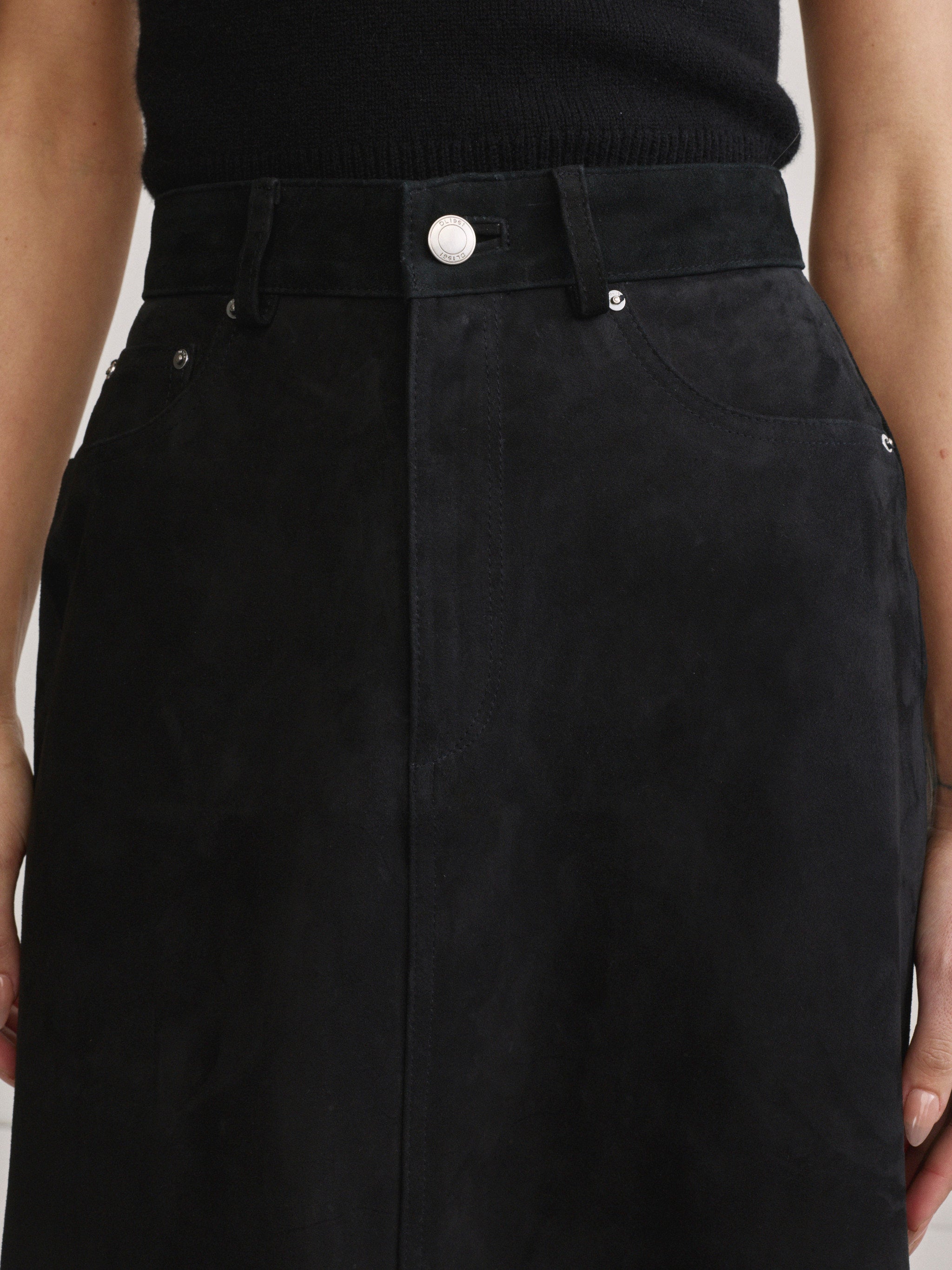 DL1961 Alma Suede Midi Skirt in Black Suede, close-up of waistband and button detail.