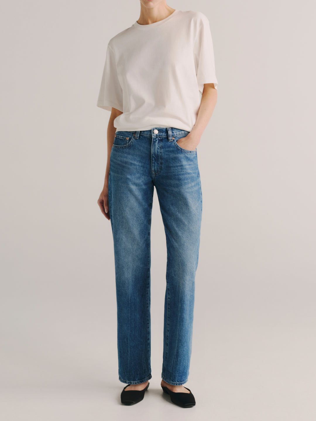 Dakota Slim Straight jeans in Endless Sea, model standing arms crossed, full-length front view.