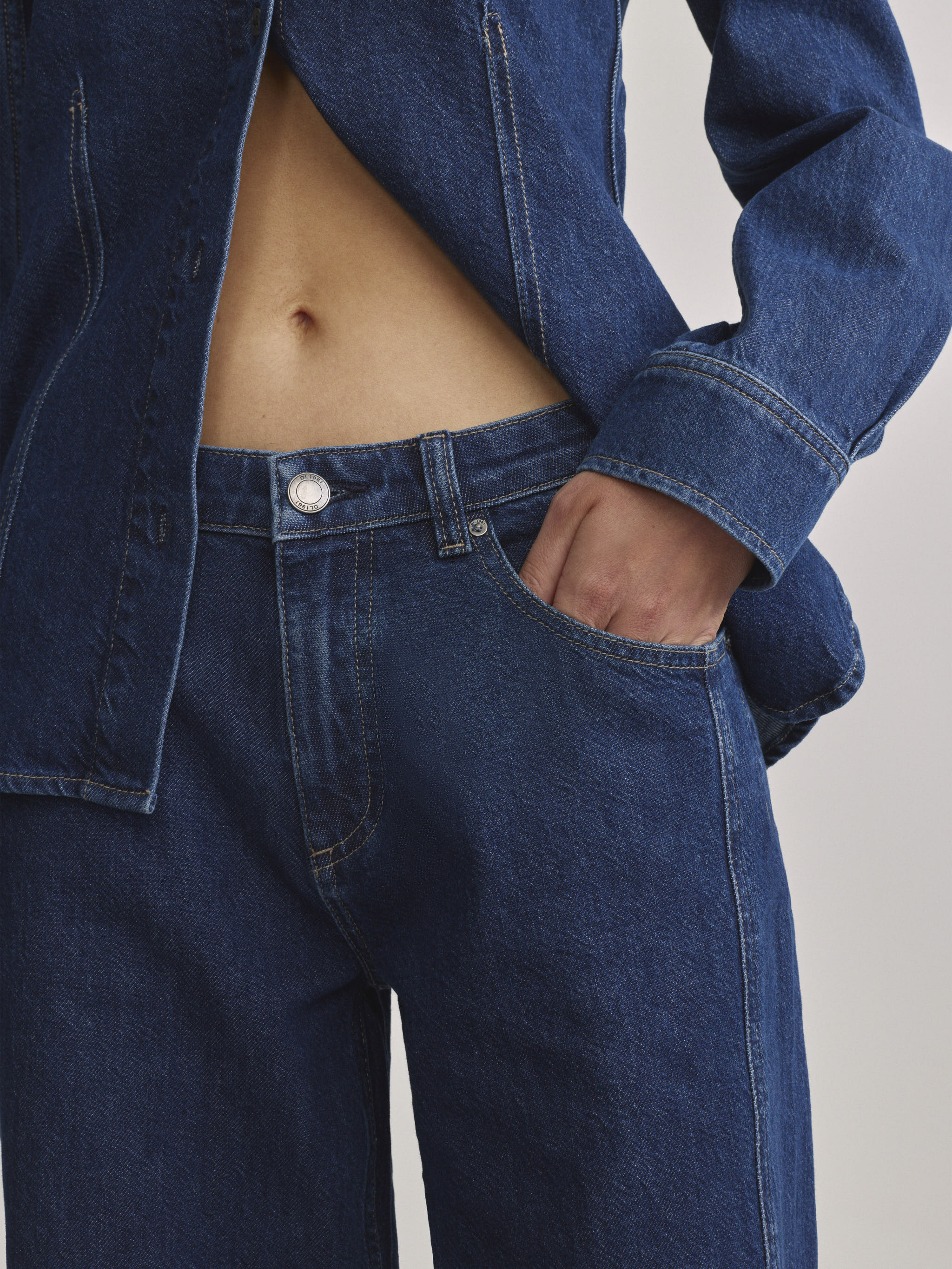 DL1961 Alex baggy wide-leg low-rise jeans in blue indigo 'Inkwell Aura', close-up of low rise and silver-button waist.