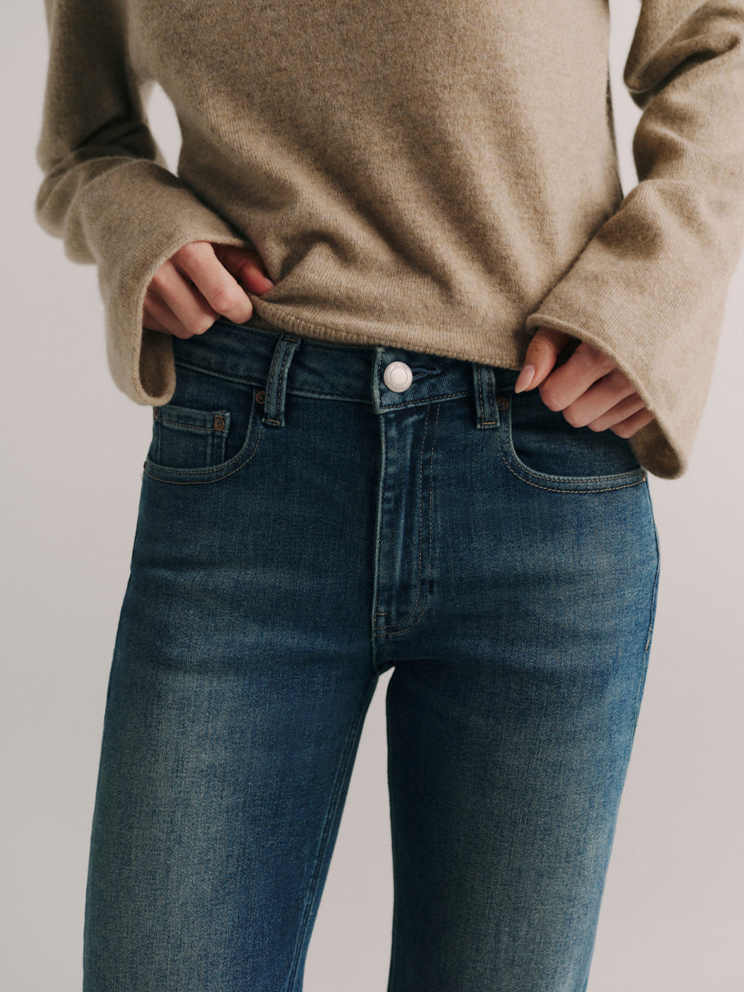 DL1961 Bella Slim Bootcut mid-rise jeans in faded medium-blue 'Deep Willow', close-up of front waist.