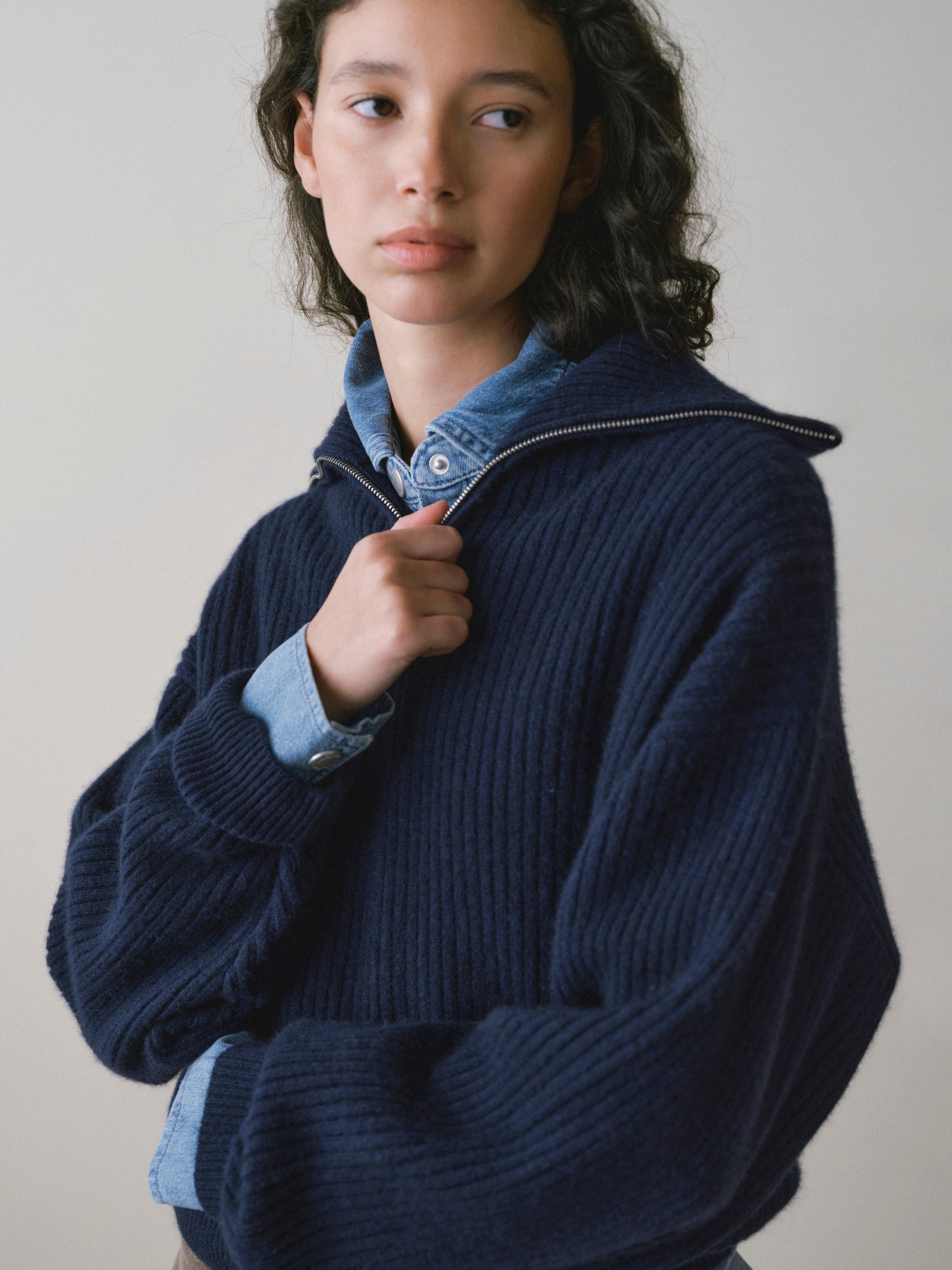 DL1961 women's Robbie oversized zip up sweater in navy 'Colter Bay', close-up of the half-zip placket over a denim shirt.