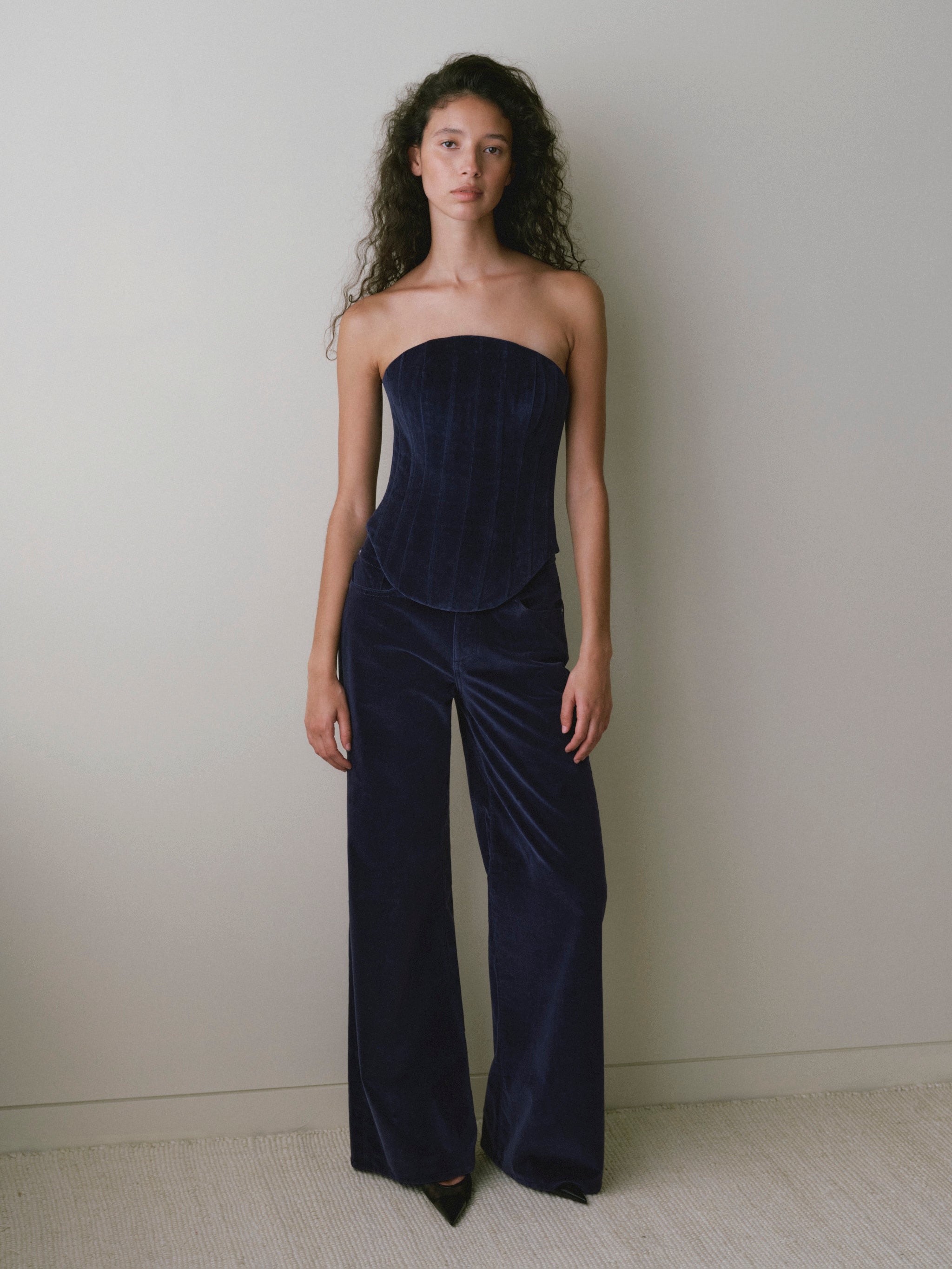 DL1961 women's strapless corset top in navy 'Ajax Velvet', full-length front view with matching velvet wide leg pants.
