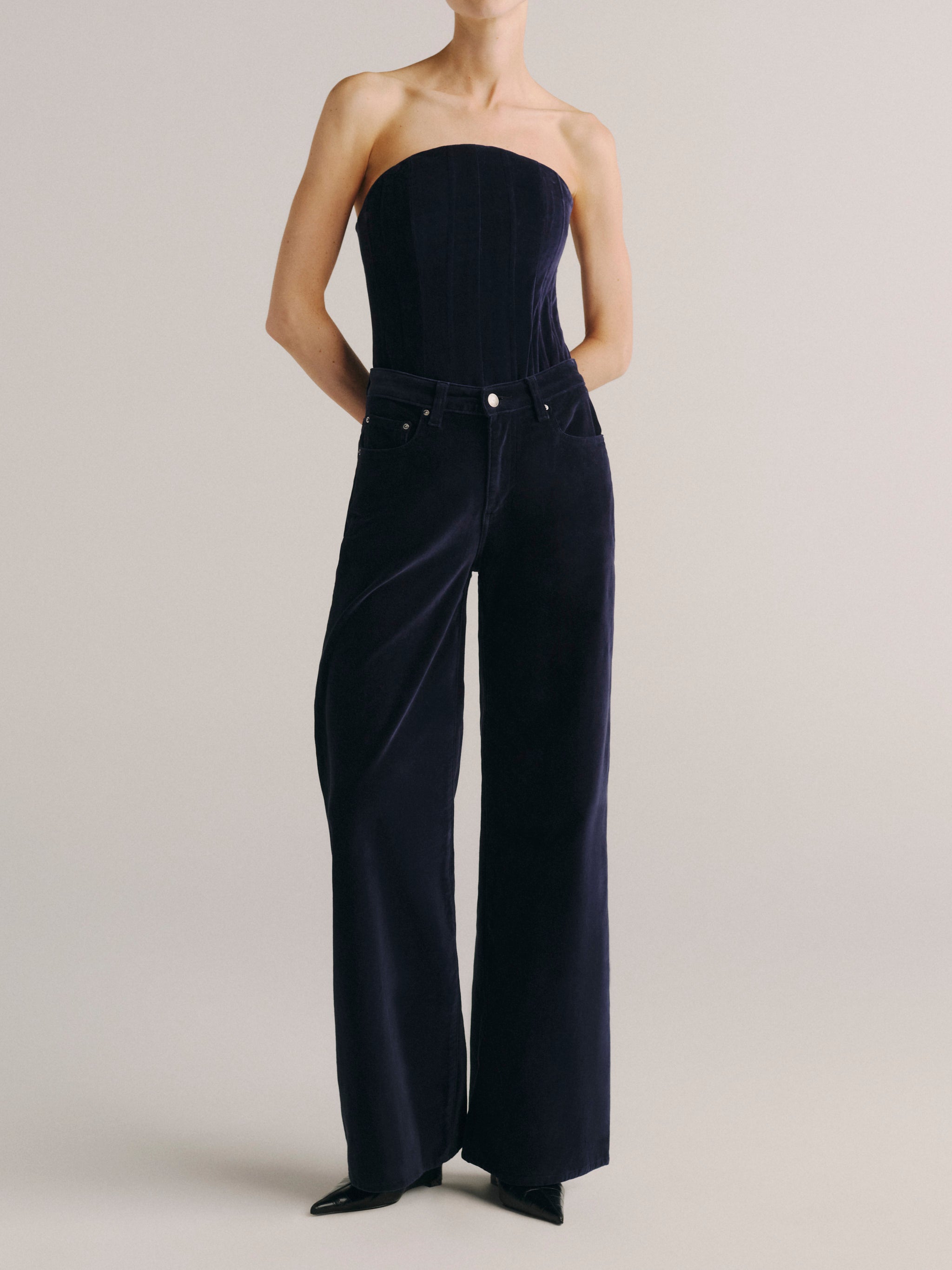 DL1961 women's strapless corset top in navy 'Ajax Velvet', full-length front view with matching wide leg velvet jeans.