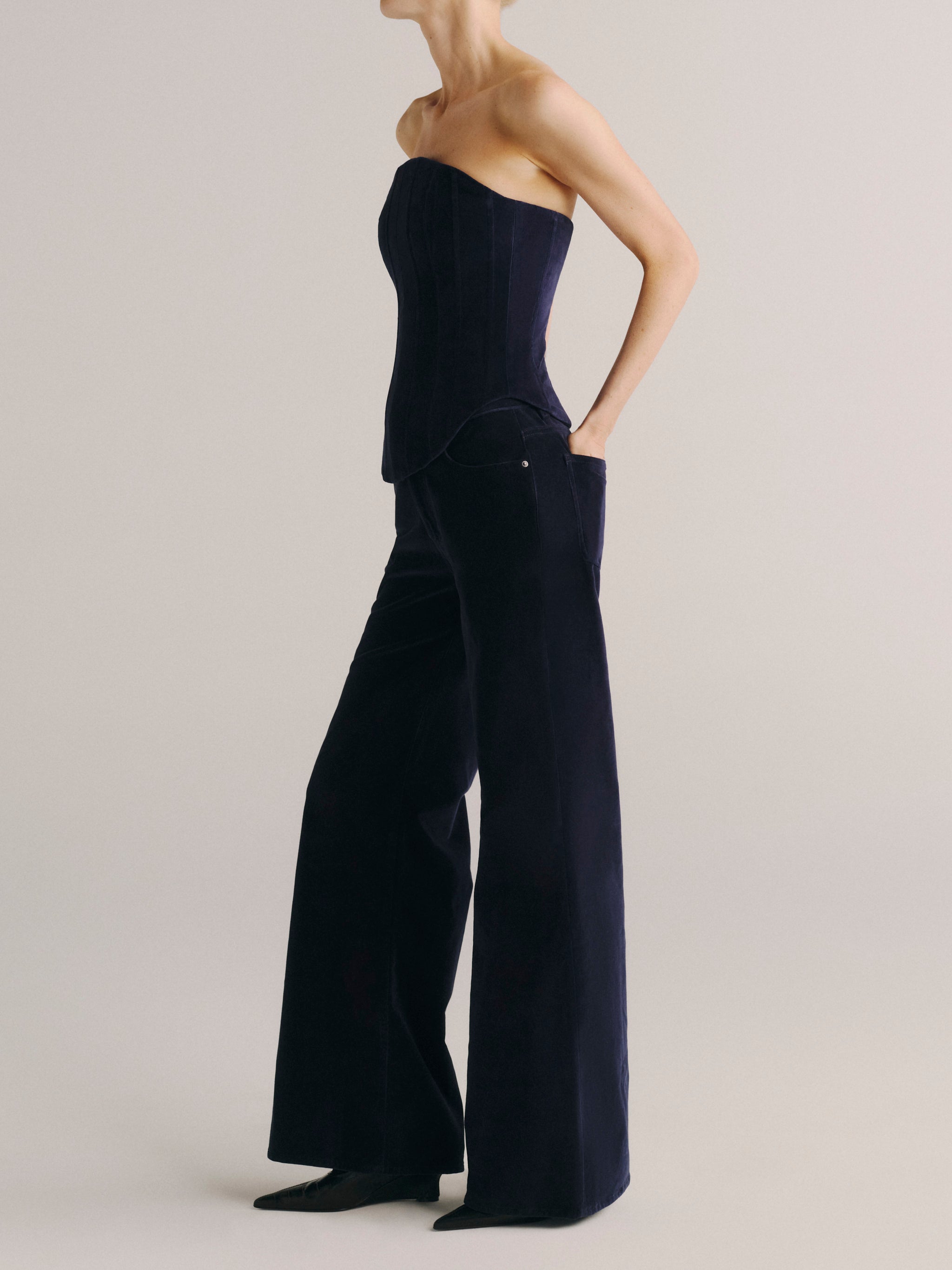 DL1961 women's strapless corset top in navy 'Ajax Velvet', side view showing the fitted bodice and curved hem.