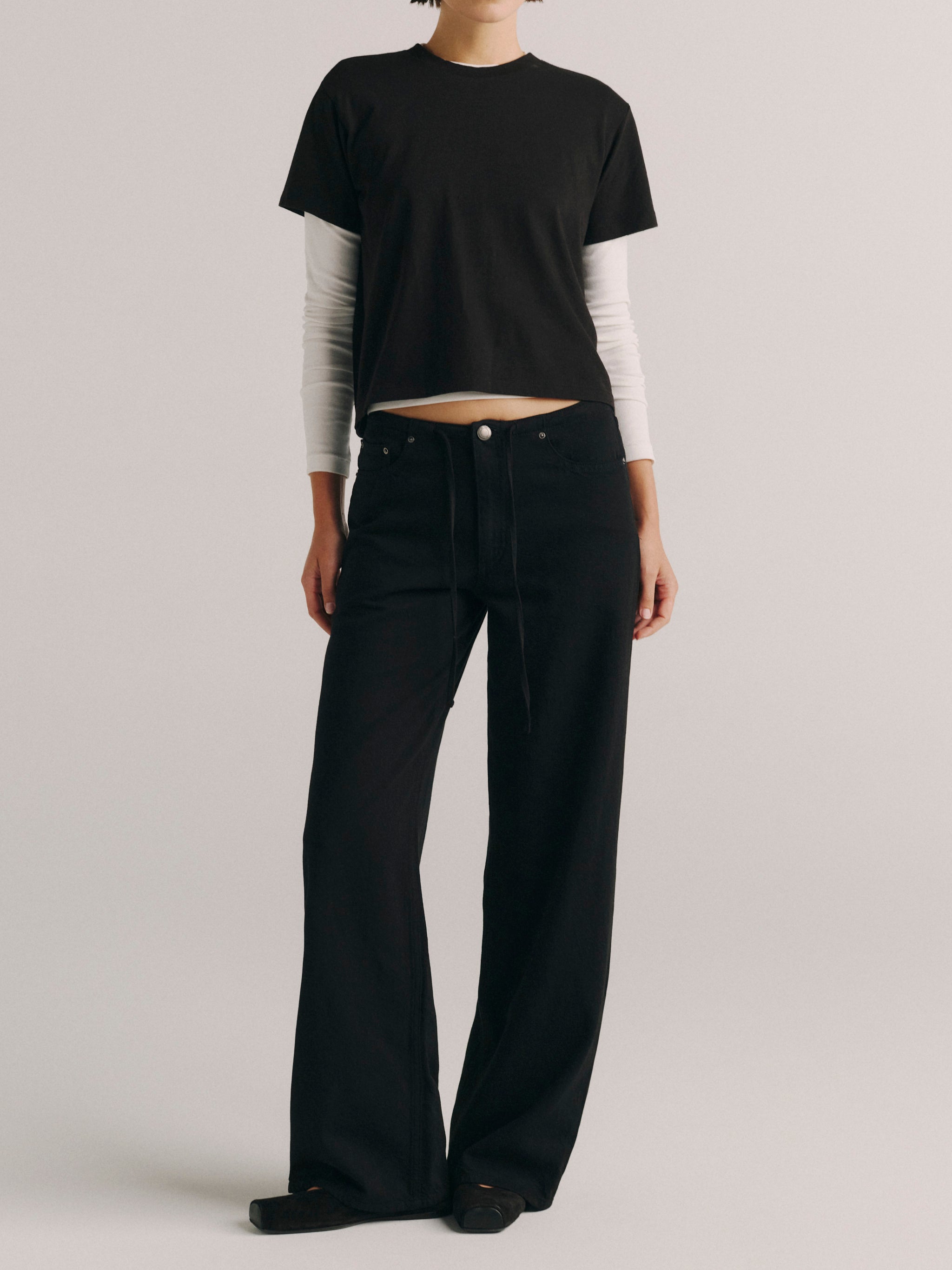 DL1961 women's Sienna Low-Slung Drawstring Wide Leg jeans in black 'Black Aura', front view with a black tee and layered long sleeve.