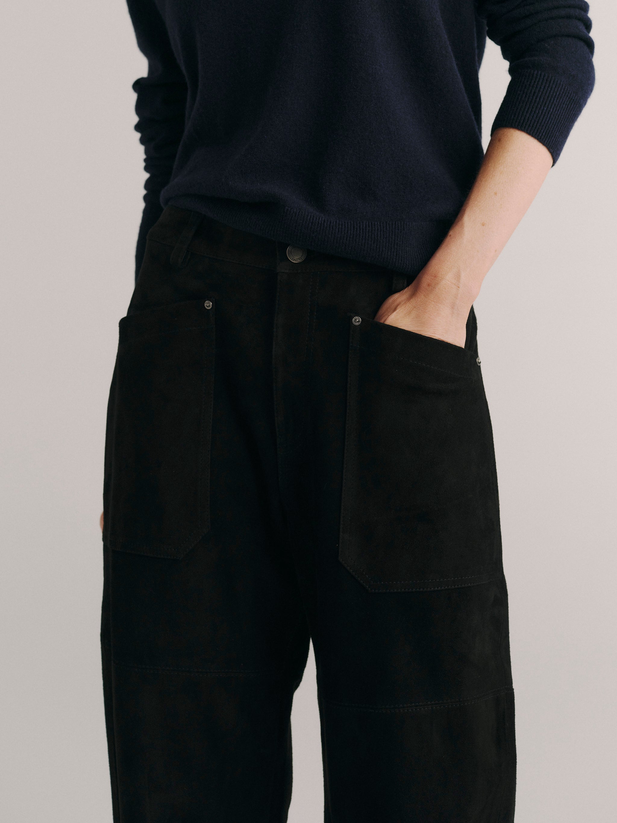 DL1961 women's Bilie Easy Barrel suede pants in black, close-up of the patch pocket and suede texture.