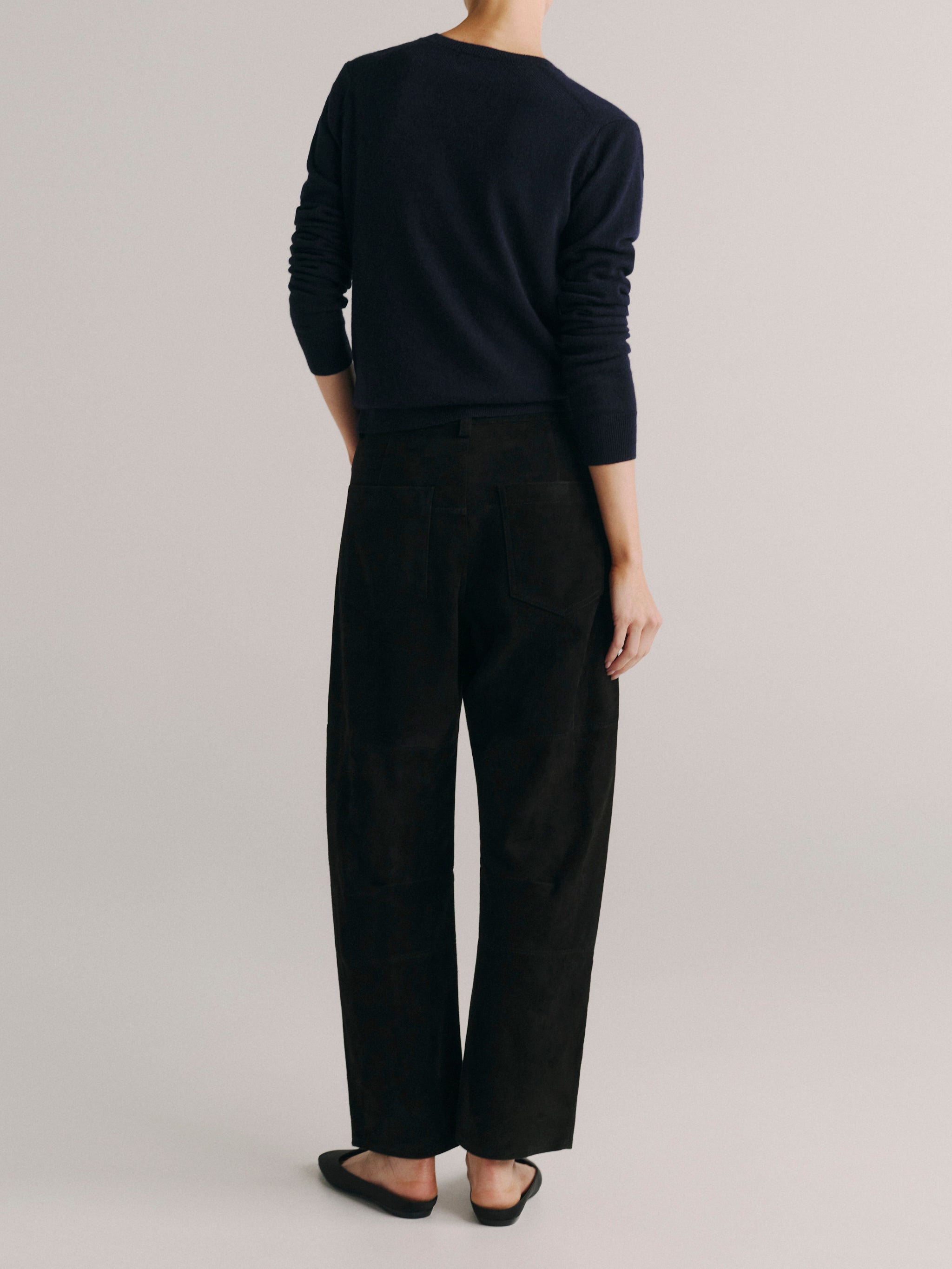 DL1961 women's Bilie Easy Barrel suede pants in black, back view showing the barrel leg.