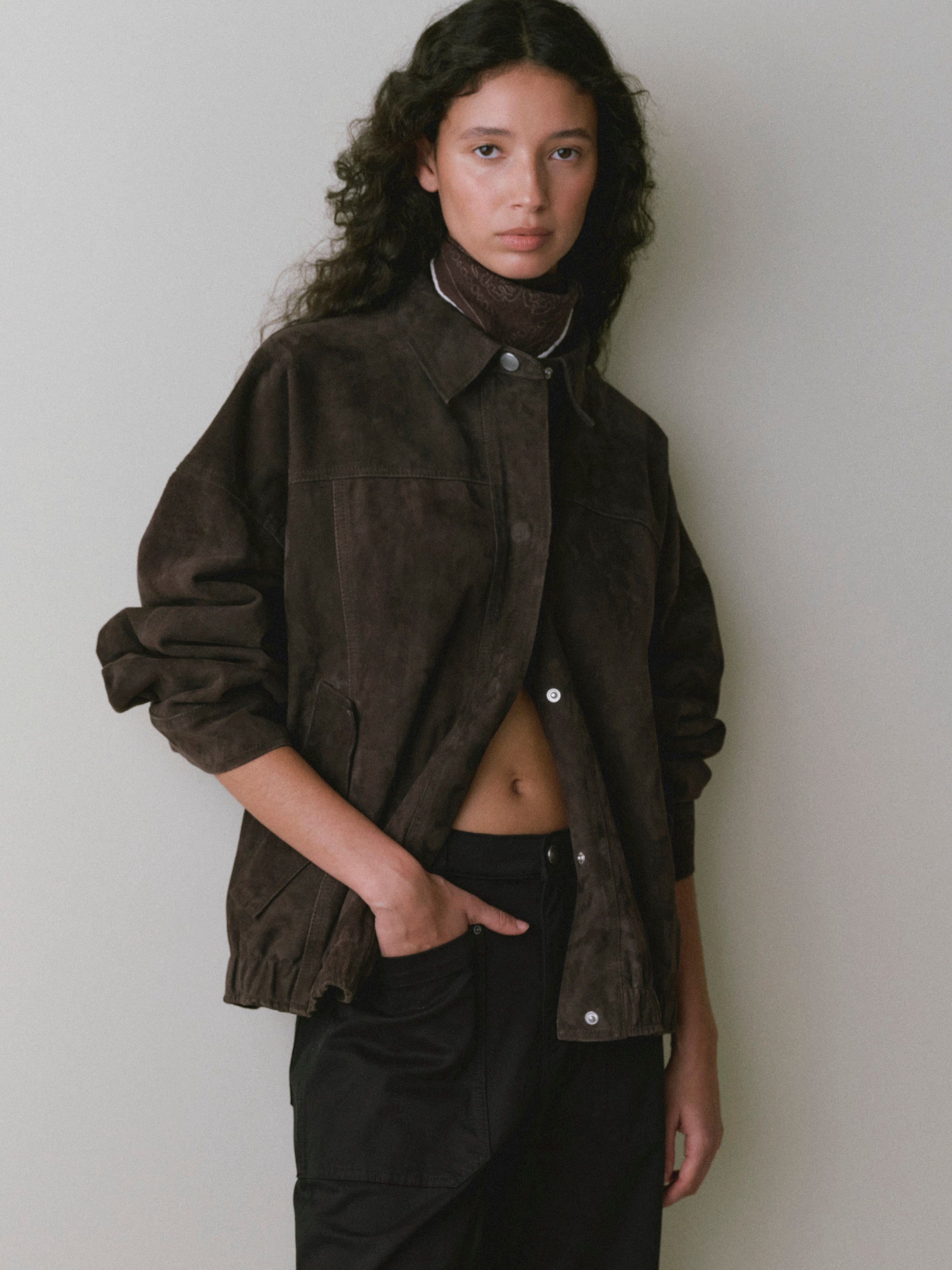 DL1961 women's Nara oversized suede jacket in tobacco brown, front view worn open over black pants.