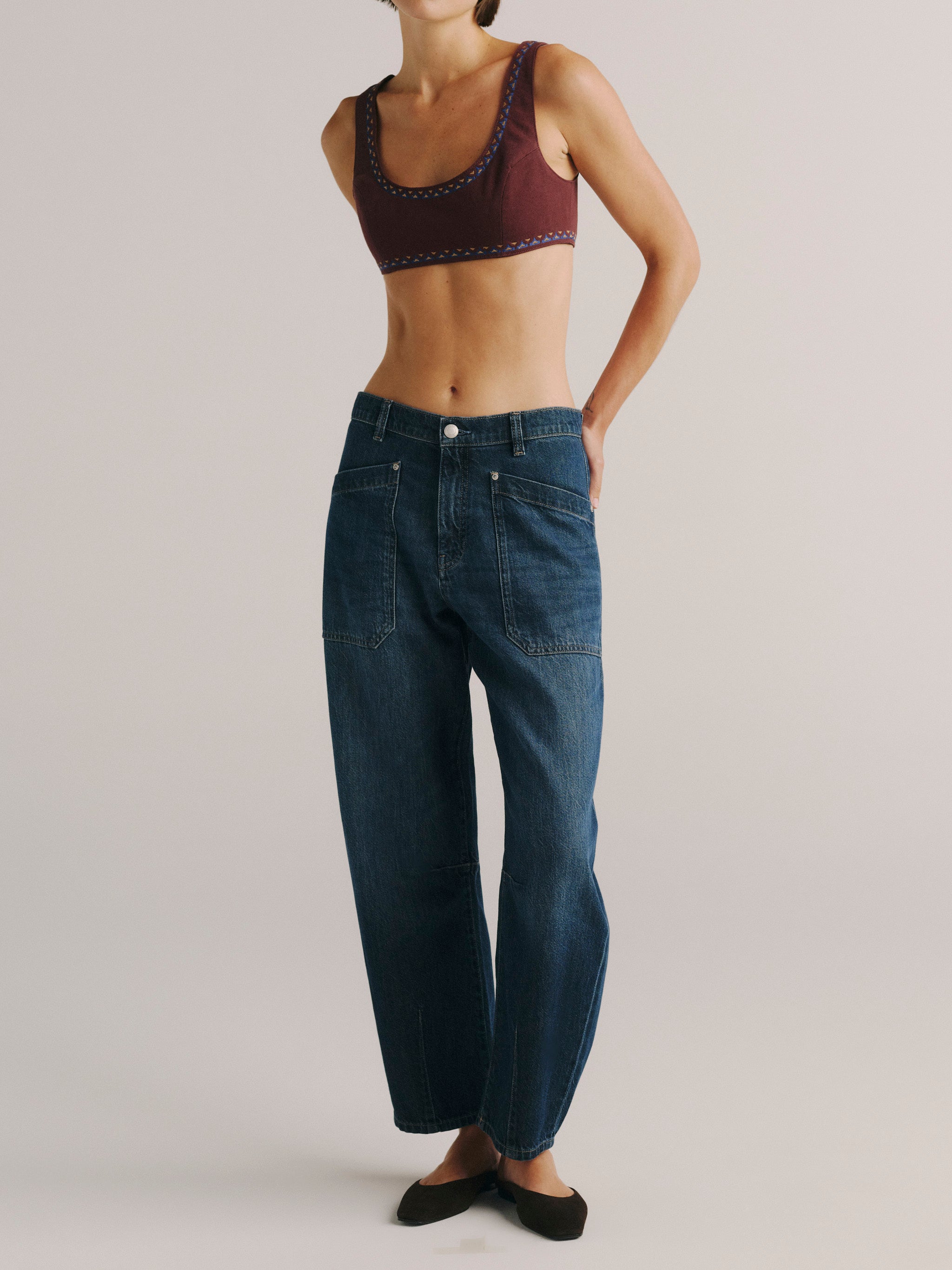 DL1961 women's Colette denim bralette in 'Burgundy Embroidery', full-length front view with blue barrel jeans.