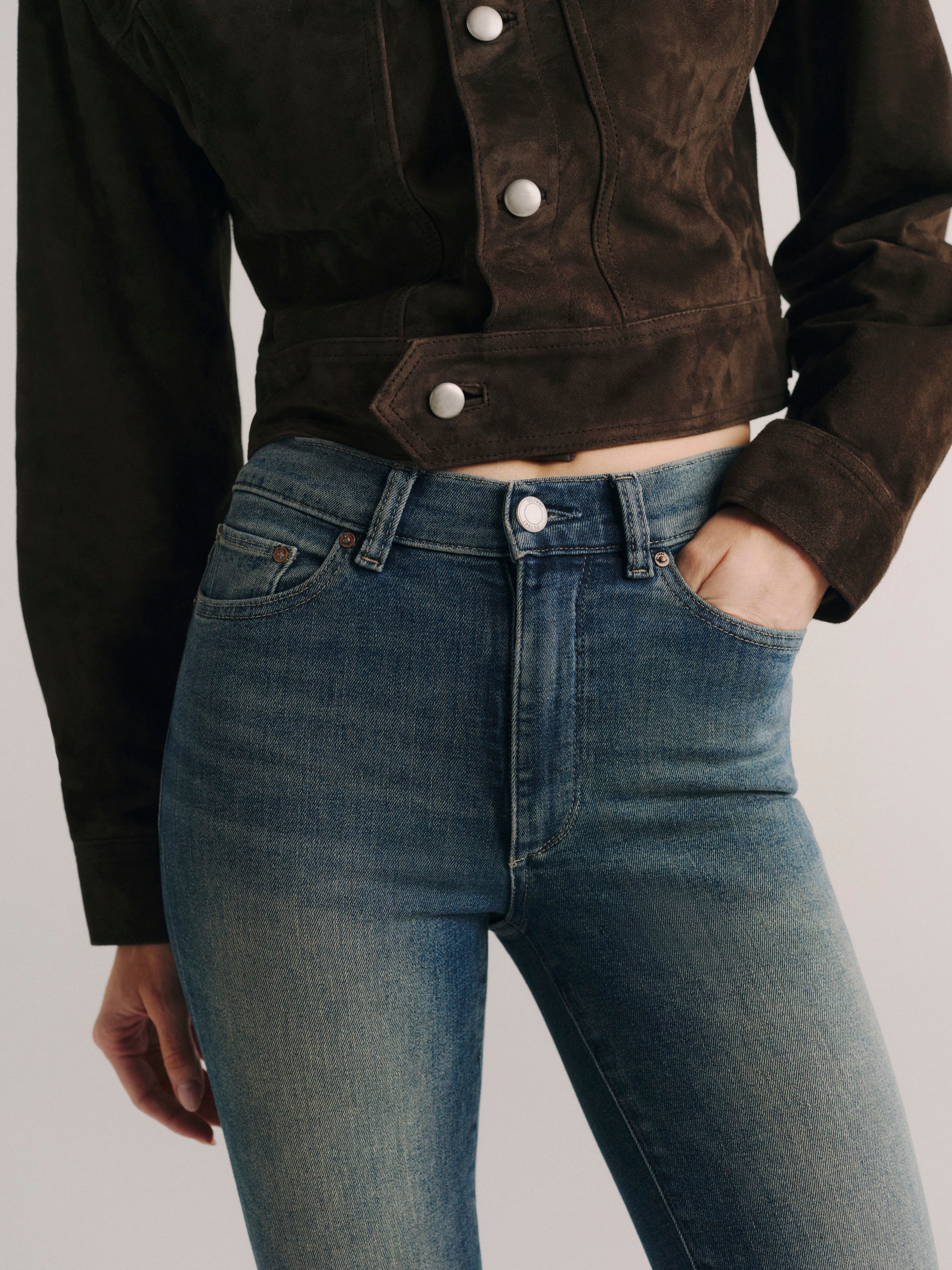DL1961 women's Bridget Bootcut High Rise Instasculpt jeans in medium blue 'Eternal', close-up of the high rise waist and front pocket.