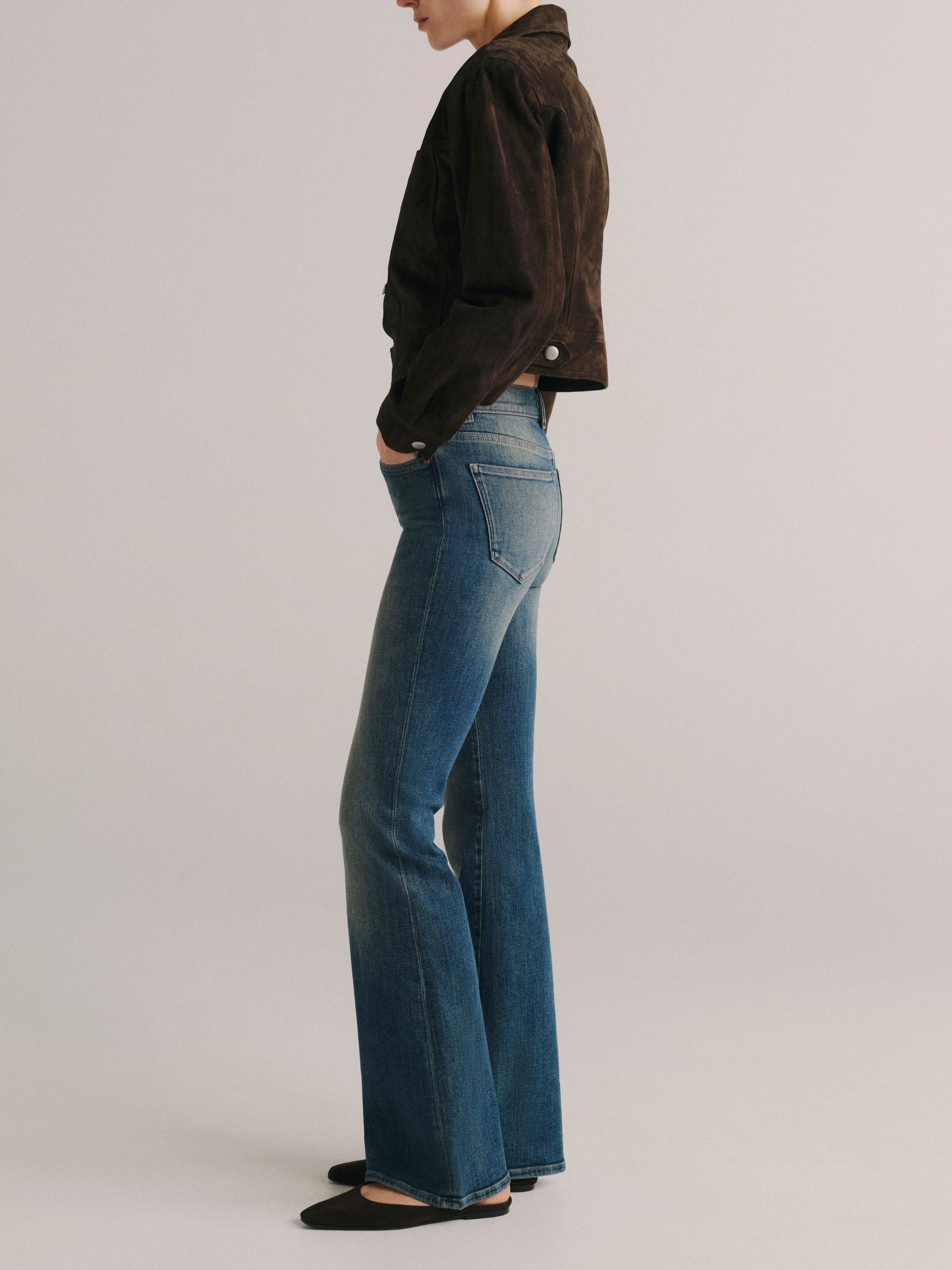 DL1961 women's Bridget Bootcut High Rise Instasculpt jeans in medium blue 'Eternal', side profile showing the flared leg.