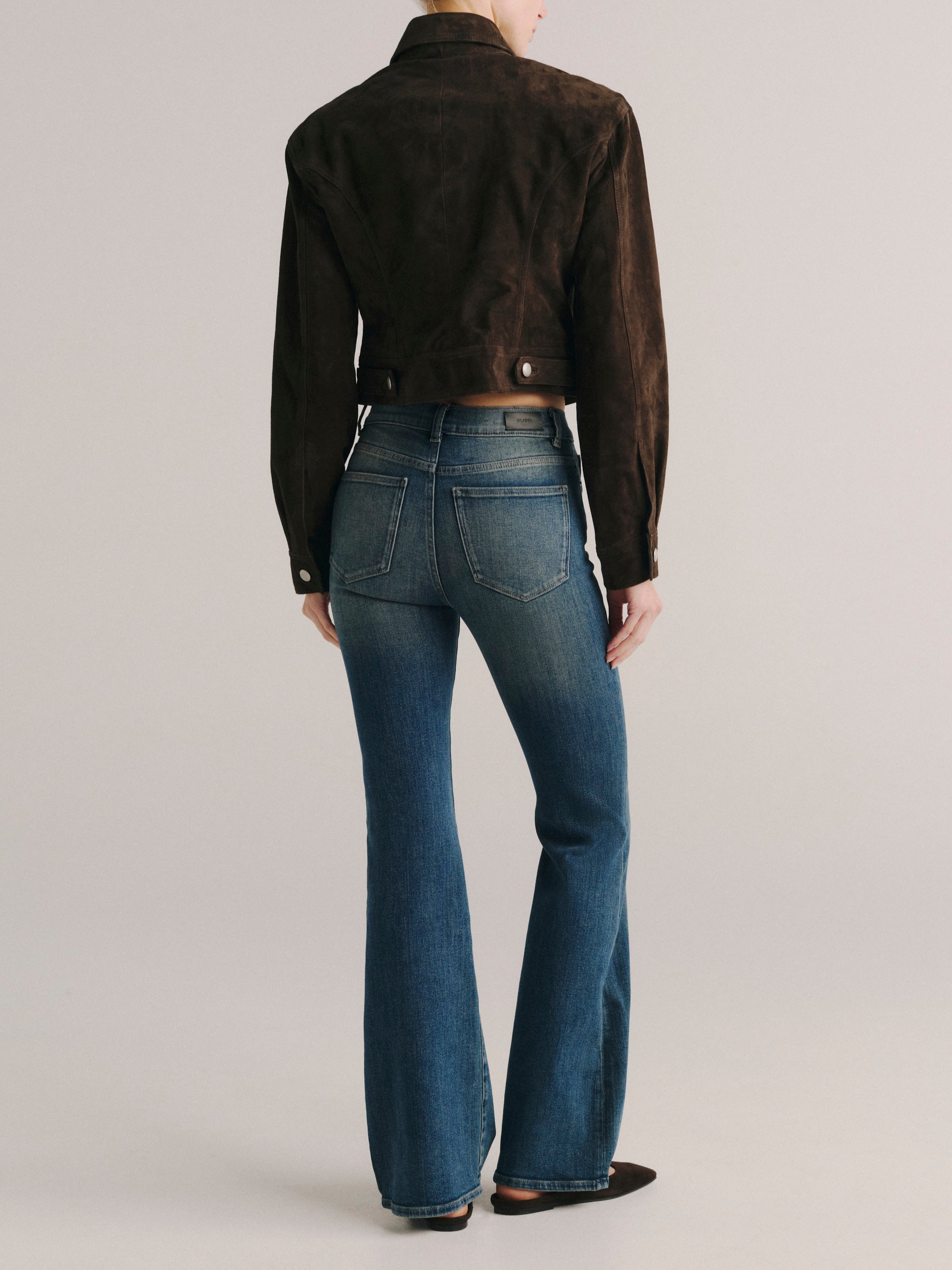 DL1961 women's Bridget Bootcut High Rise Instasculpt jeans in medium blue 'Eternal', back view showing the rear pockets and flare.