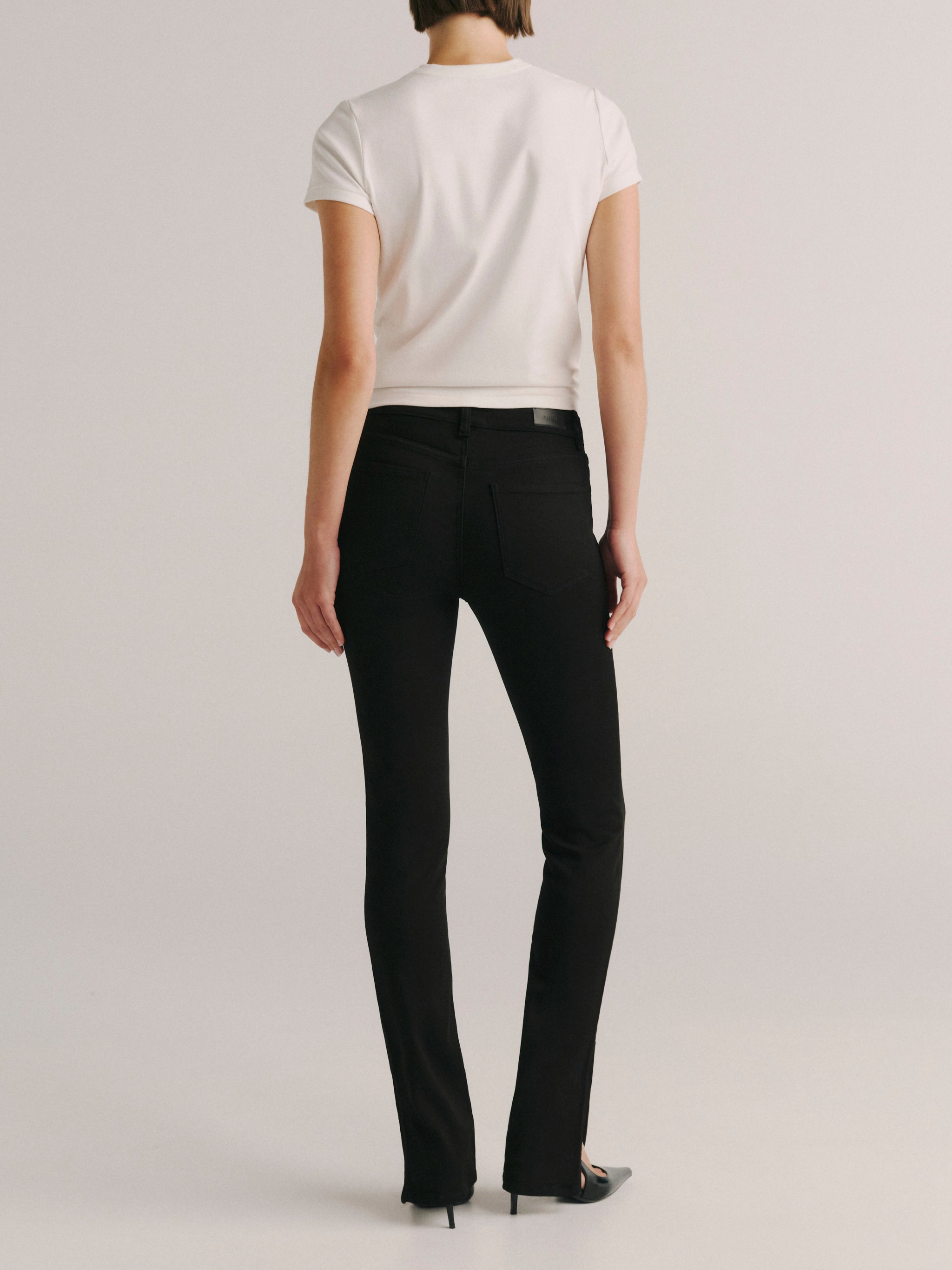 DL1961 women's Jessica Skinny Low-Rise Instasculpt jeans in black 'Cascade', back view showing the rear pockets.
