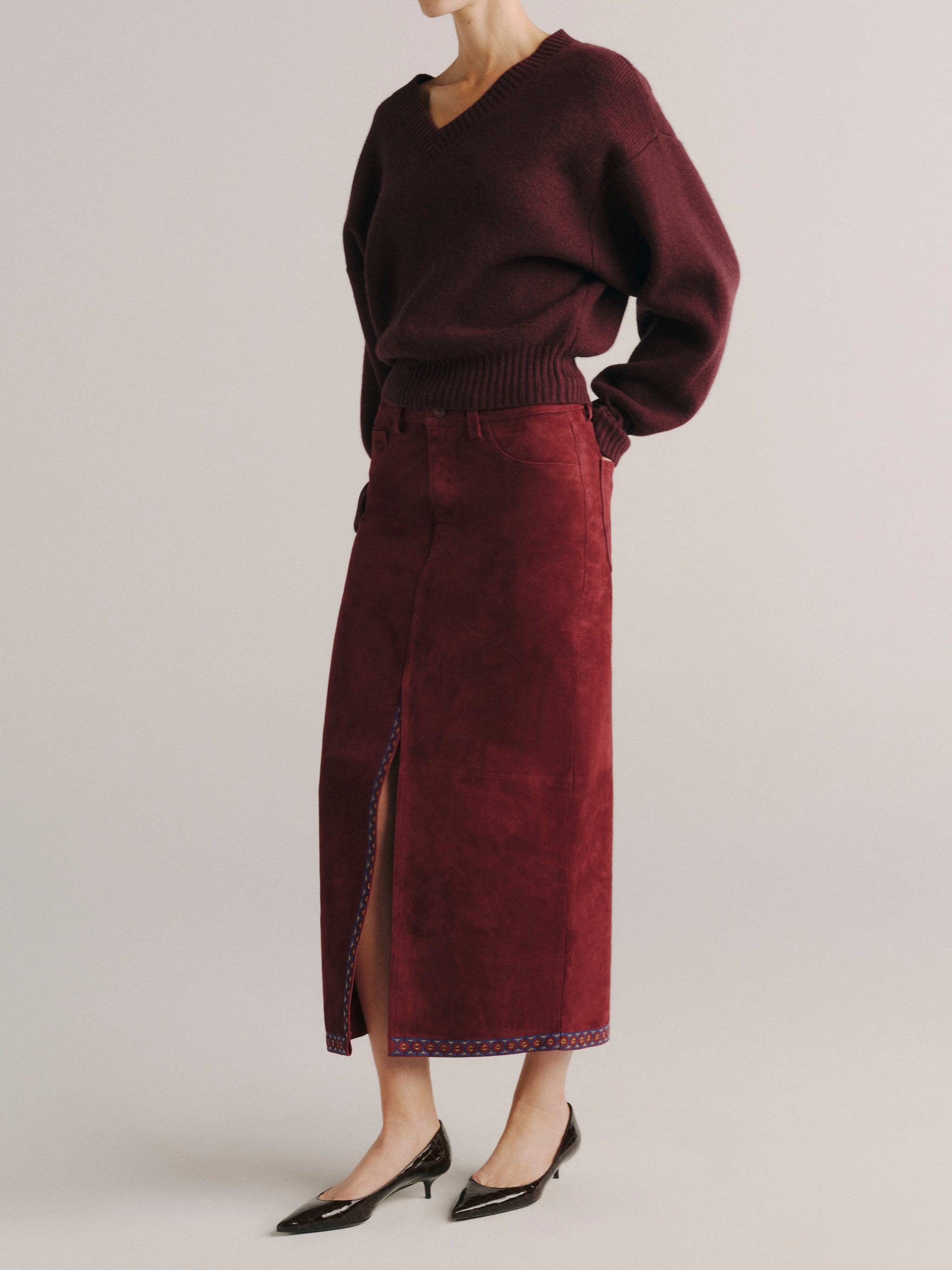 DL1961 women's Alma suede midi skirt in 'Burgundy Suede Embroidery', side view showing the front slit.