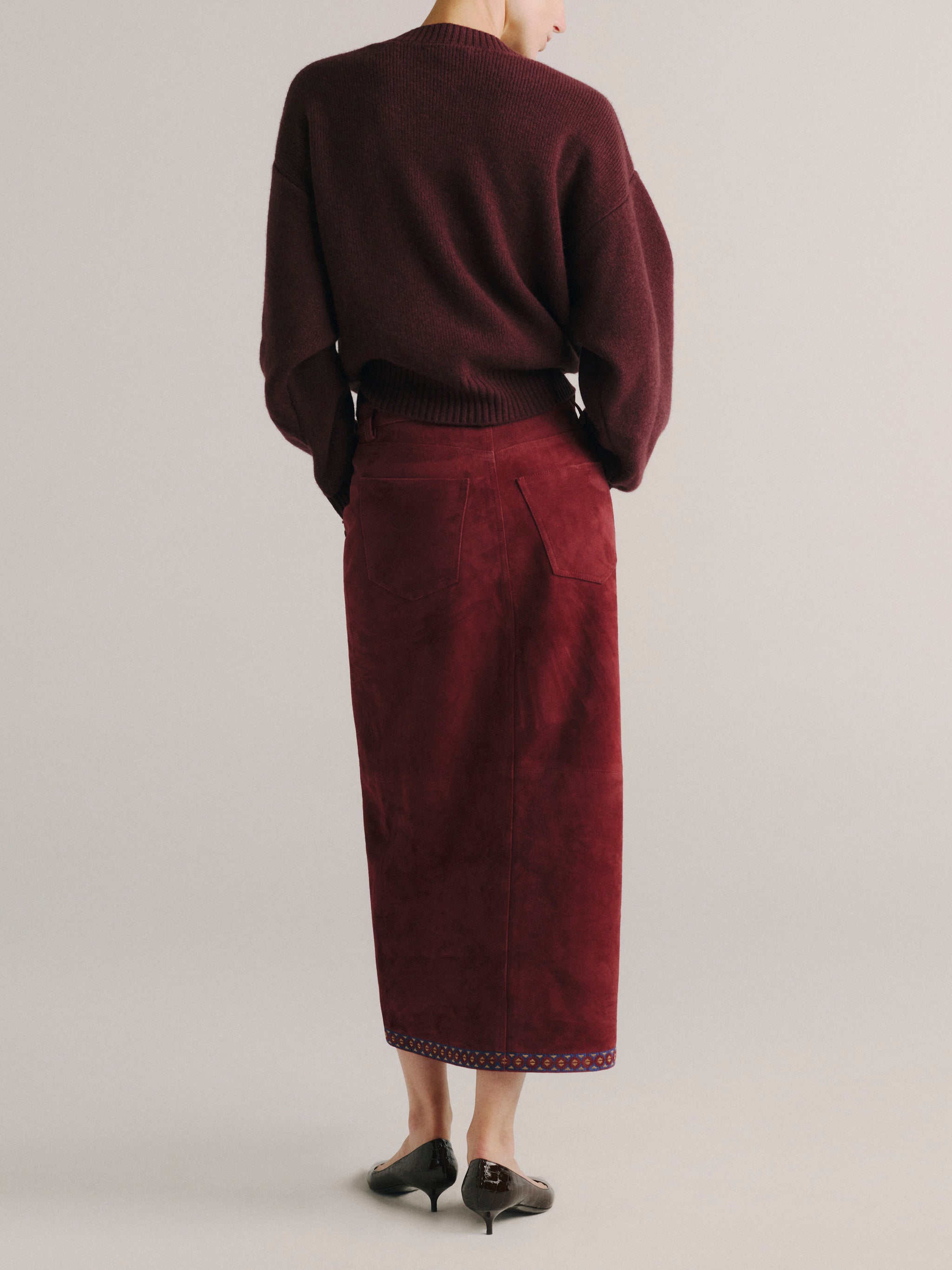 DL1961 women's Alma suede midi skirt in 'Burgundy Suede Embroidery', back view showing the straight midi silhouette.