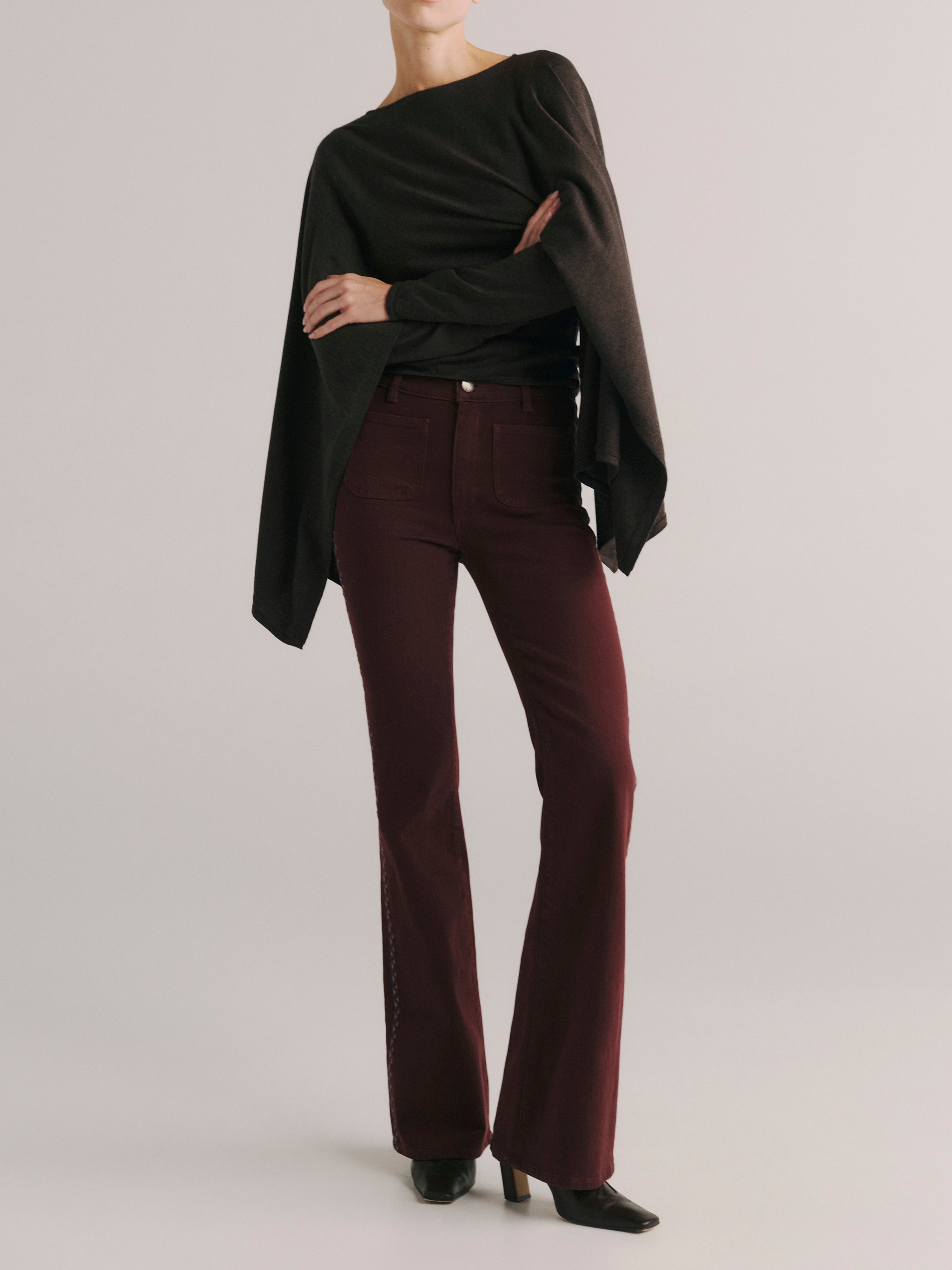 DL1961 women's Bridget Bootcut High Rise Instasculpt jeans in 'Burgundy Embroidery', front view with a draped black top.