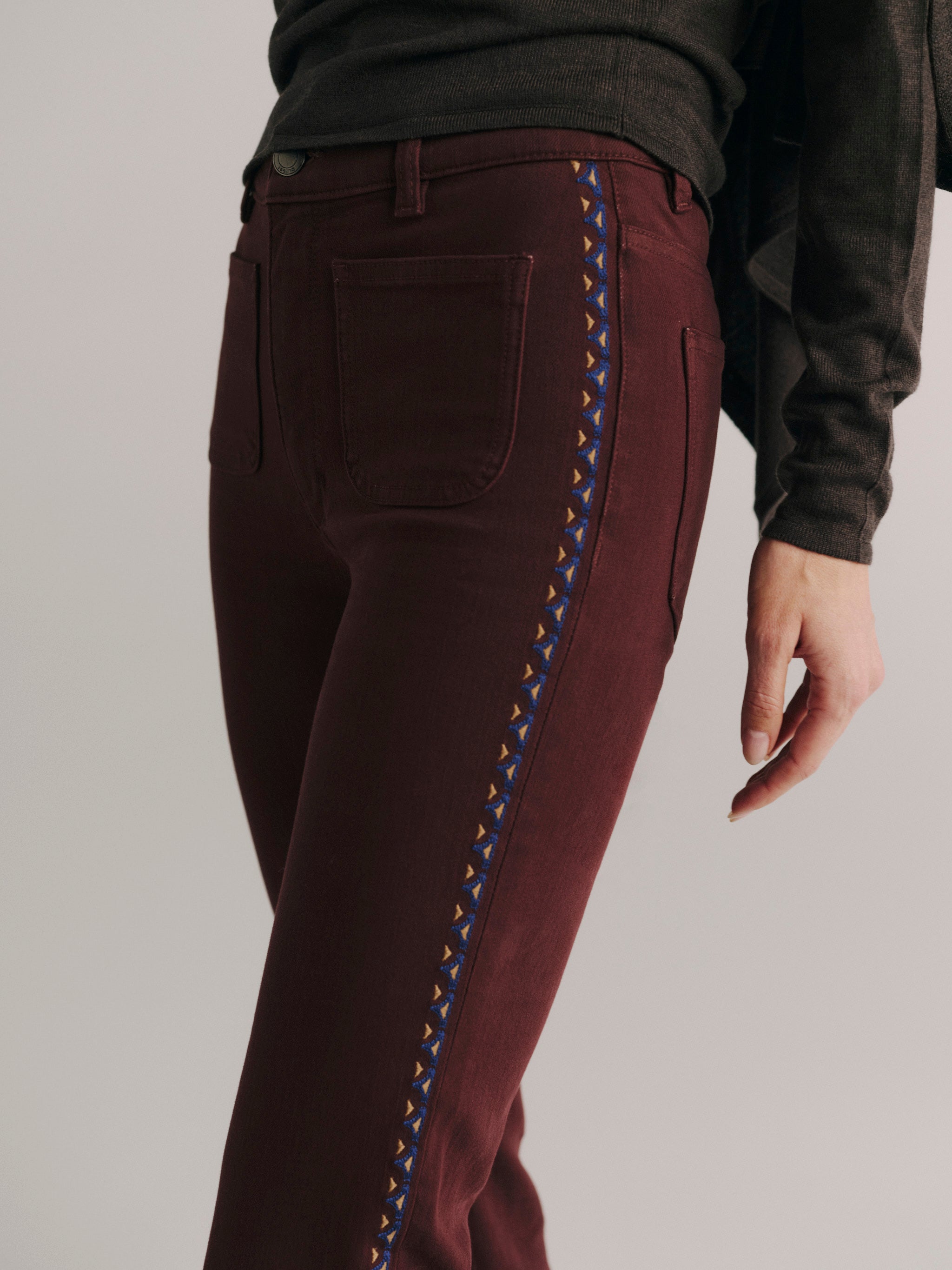 DL1961 women's Bridget Bootcut High Rise Instasculpt jeans in 'Burgundy Embroidery', close-up of the embroidered side seam.