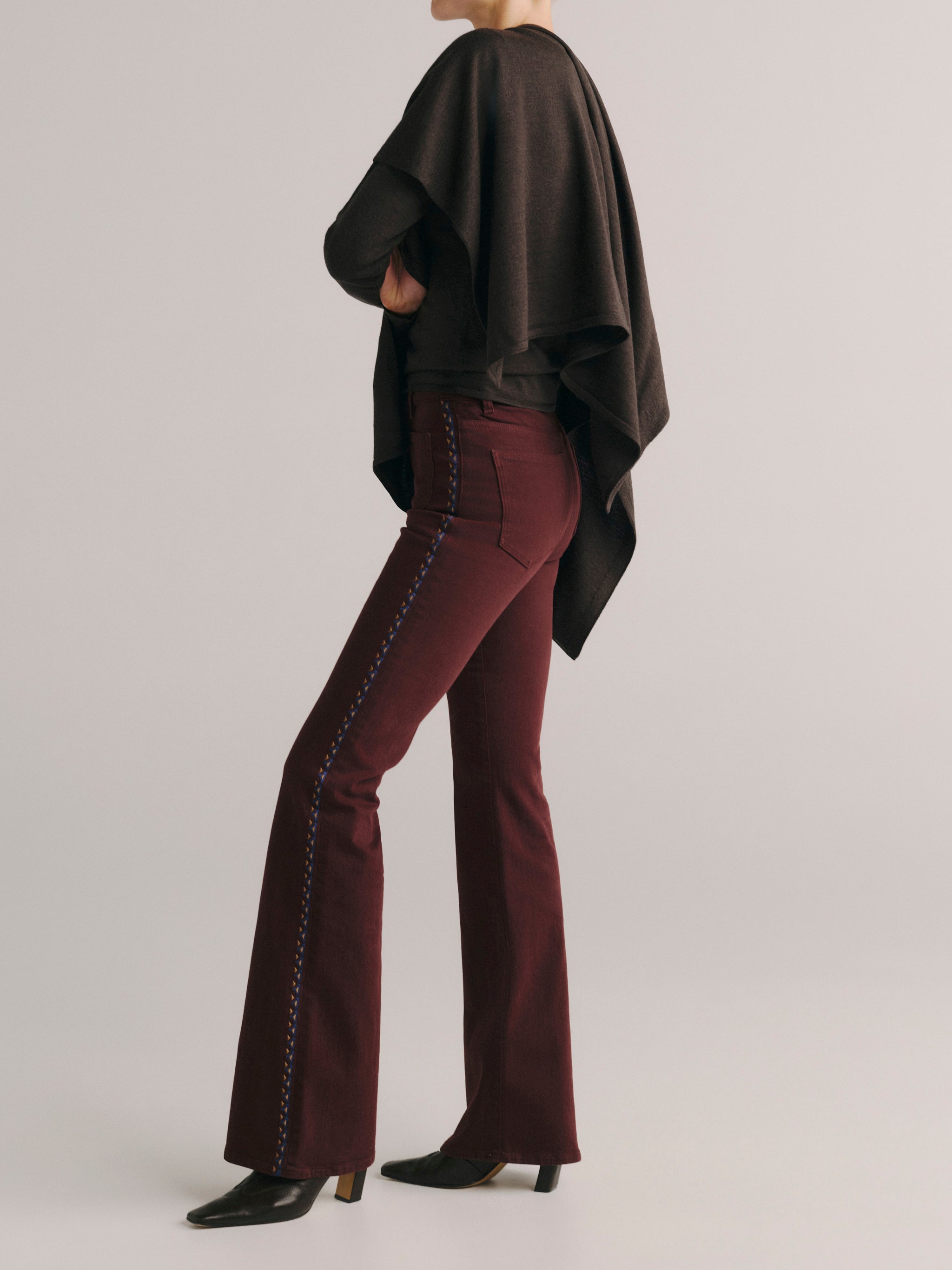 DL1961 women's Bridget Bootcut High Rise Instasculpt jeans in 'Burgundy Embroidery', side profile showing the embroidered seam and flare.