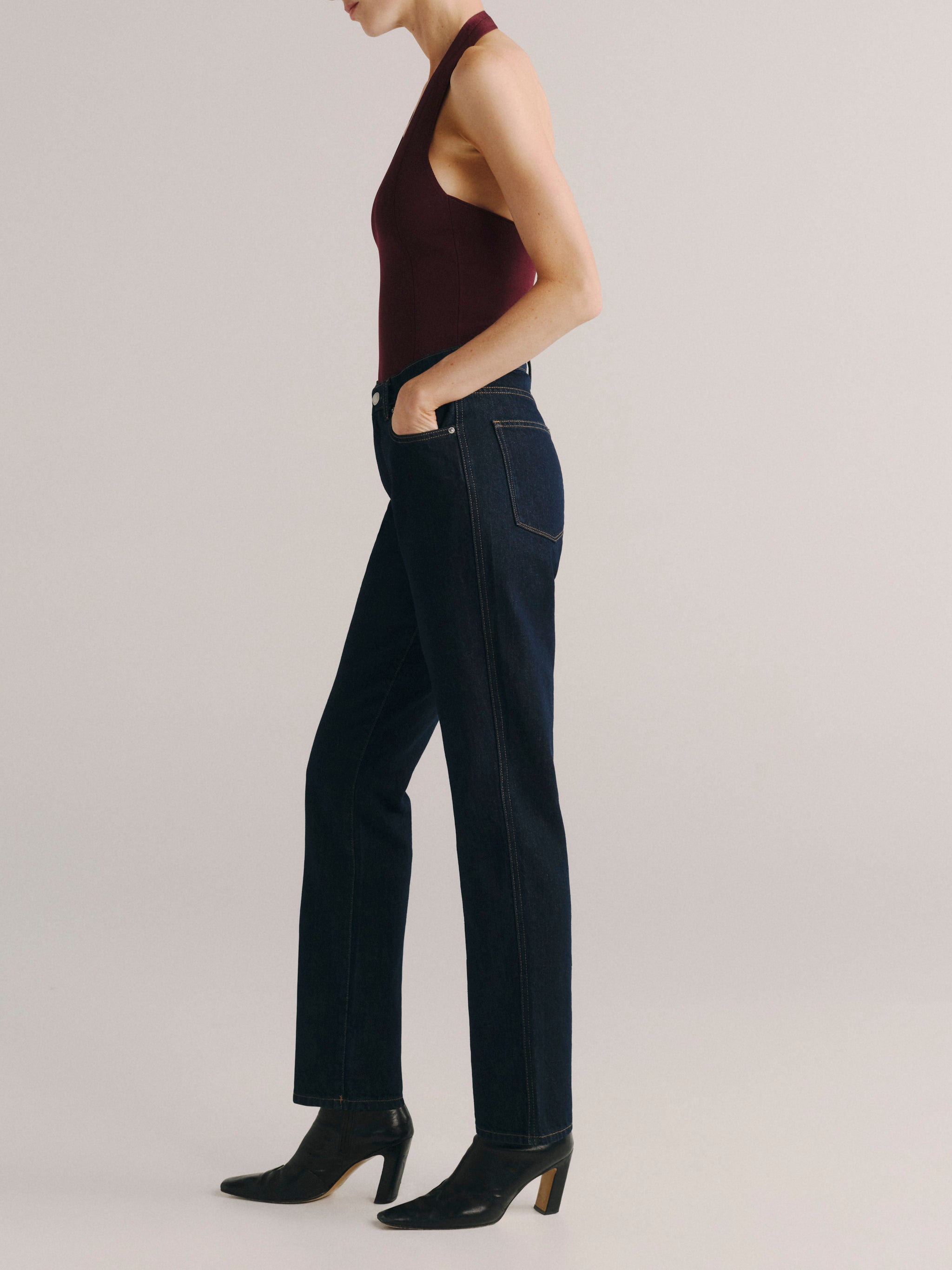 DL1961 women's Cate Classic Straight High-Rise jeans in dark indigo 'Harvest Moon', side profile showing the straight leg.