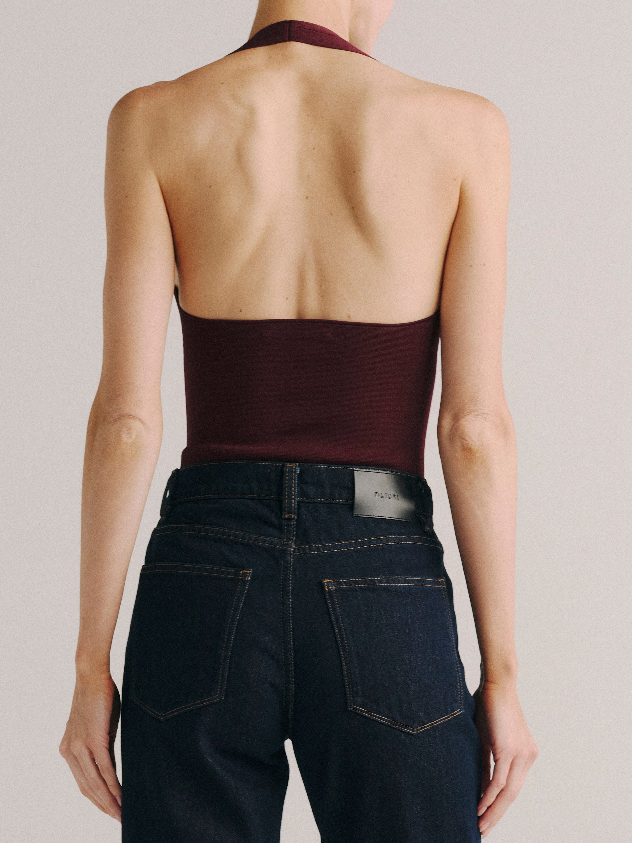 DL1961 women's Instasculpt halter bodysuit in burgundy 'Red Mountain', back view showing the open back and halter tie.
