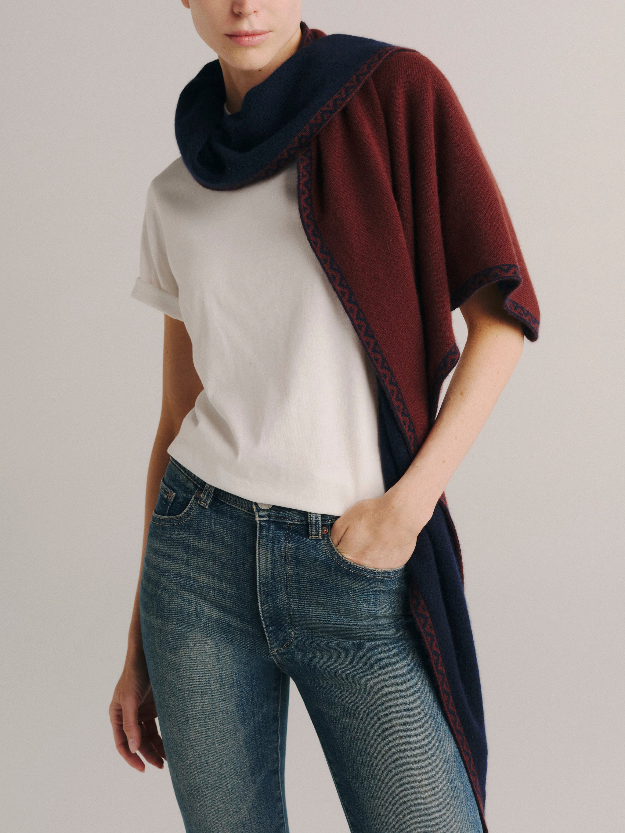 DL1961 Après-Ski scarf in burgundy with navy trim, worn draped over one shoulder with a white tee.