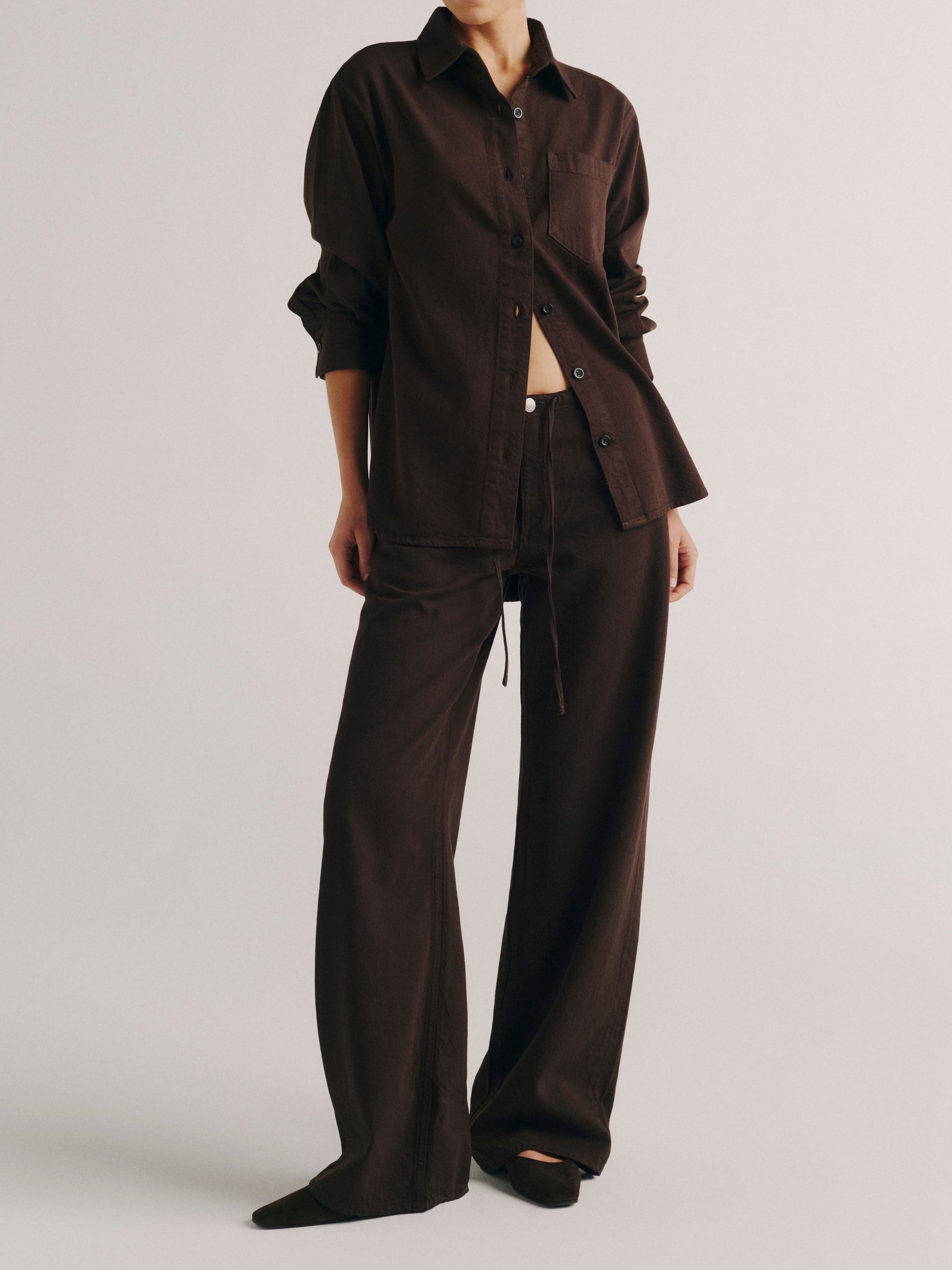 DL1961 women's Faye oversized denim shirt in dark brown 'Tobacco Aura', full-length front view with matching wide leg pants.