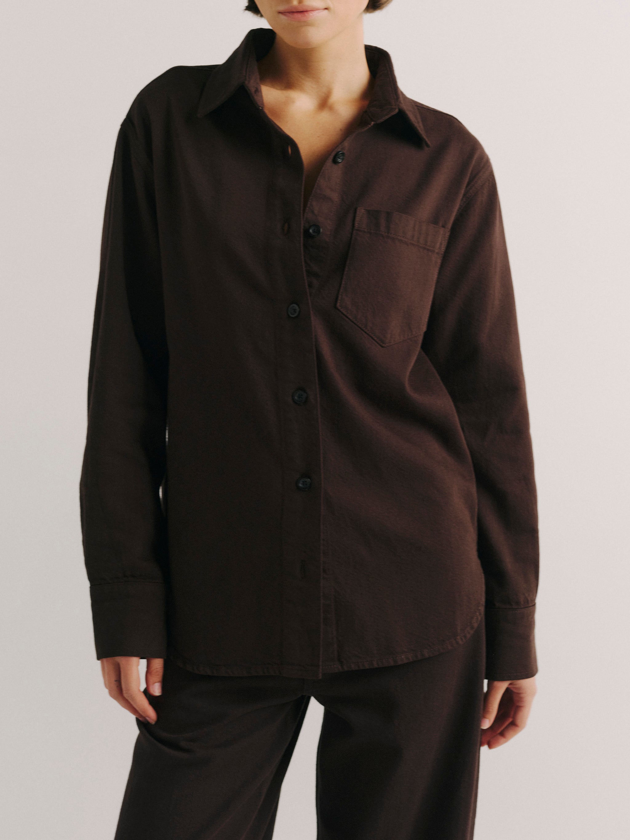 DL1961 women's Faye oversized denim shirt in dark brown 'Tobacco Aura', front view buttoned with a chest pocket.