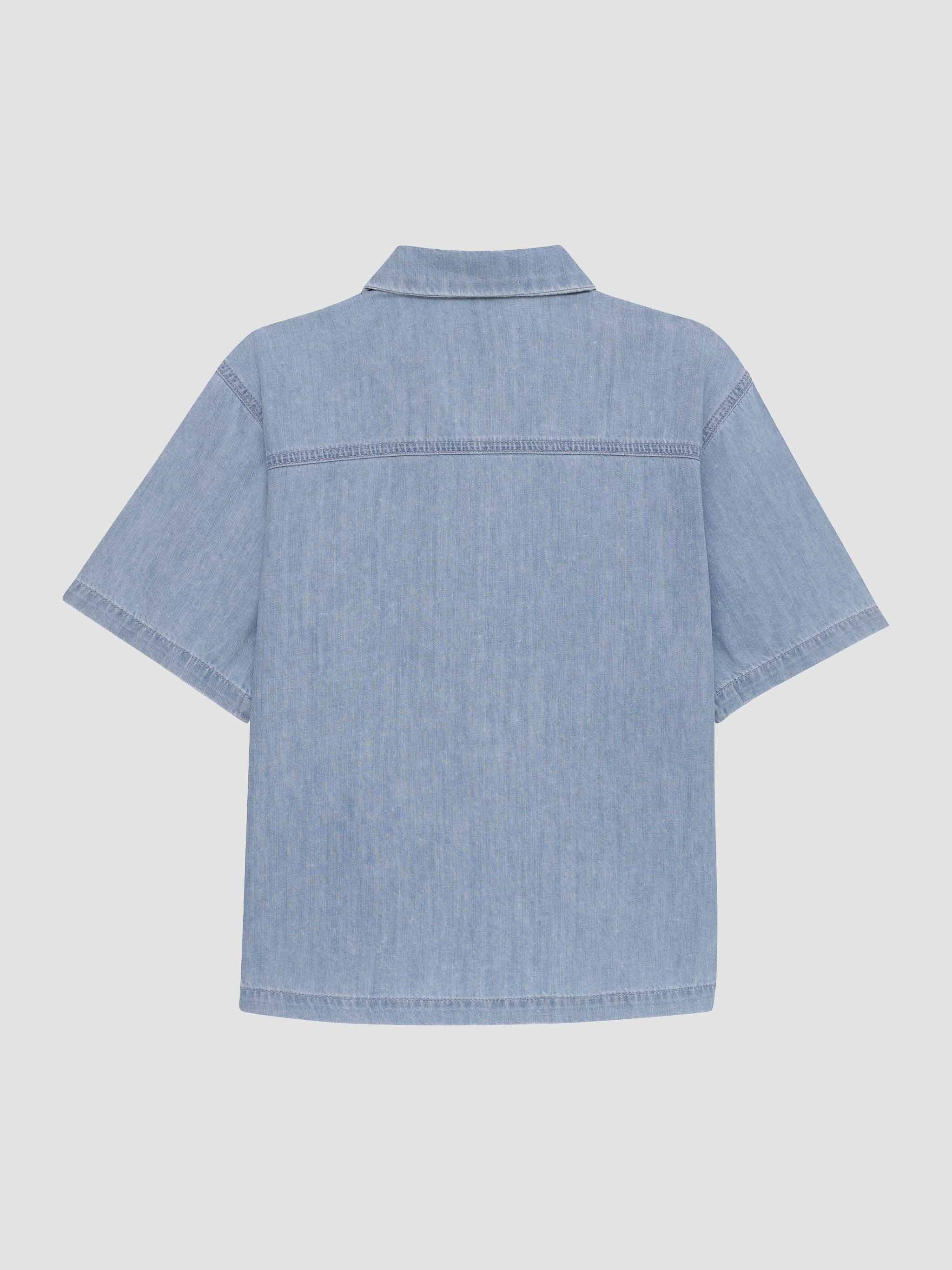 Blue denim shirt on a light gray background