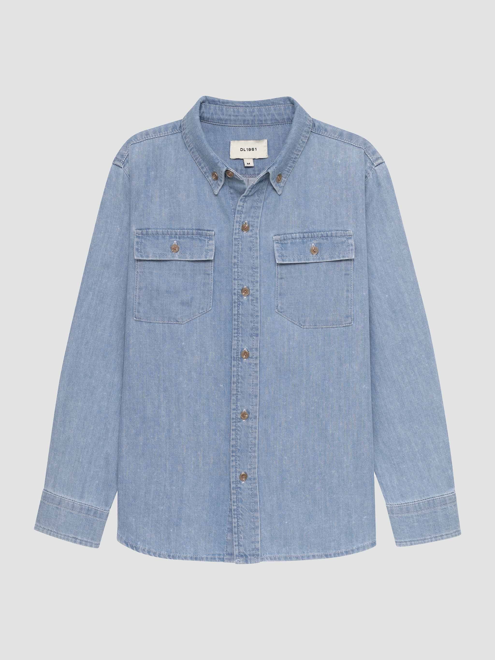 Light blue denim shirt with button details on a light gray background