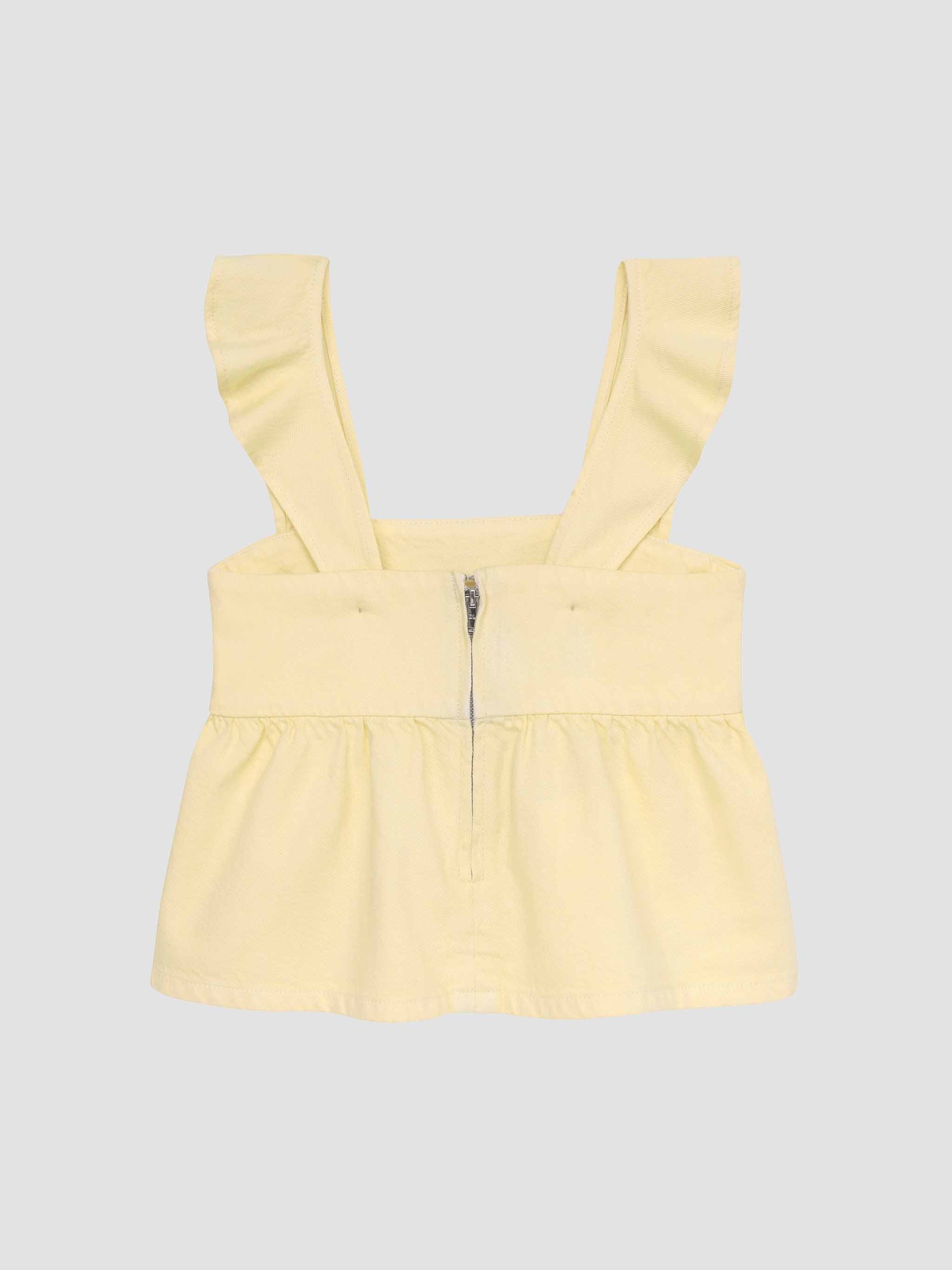 Yellow top with ruffled straps on a light gray background